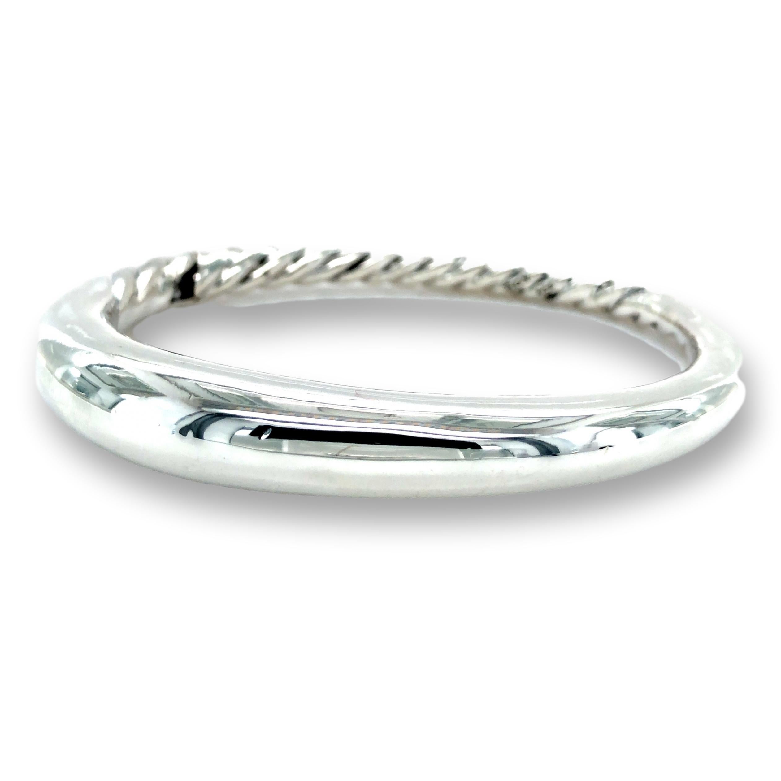 David Yurman pure form bangle bracelet finely crafted in sterling silver with a smooth front and cable twist back design 17mm at the front and 6 mm towards the back. The bracelet has a snap hinge closure. Bracelet Specifications

BRACELET