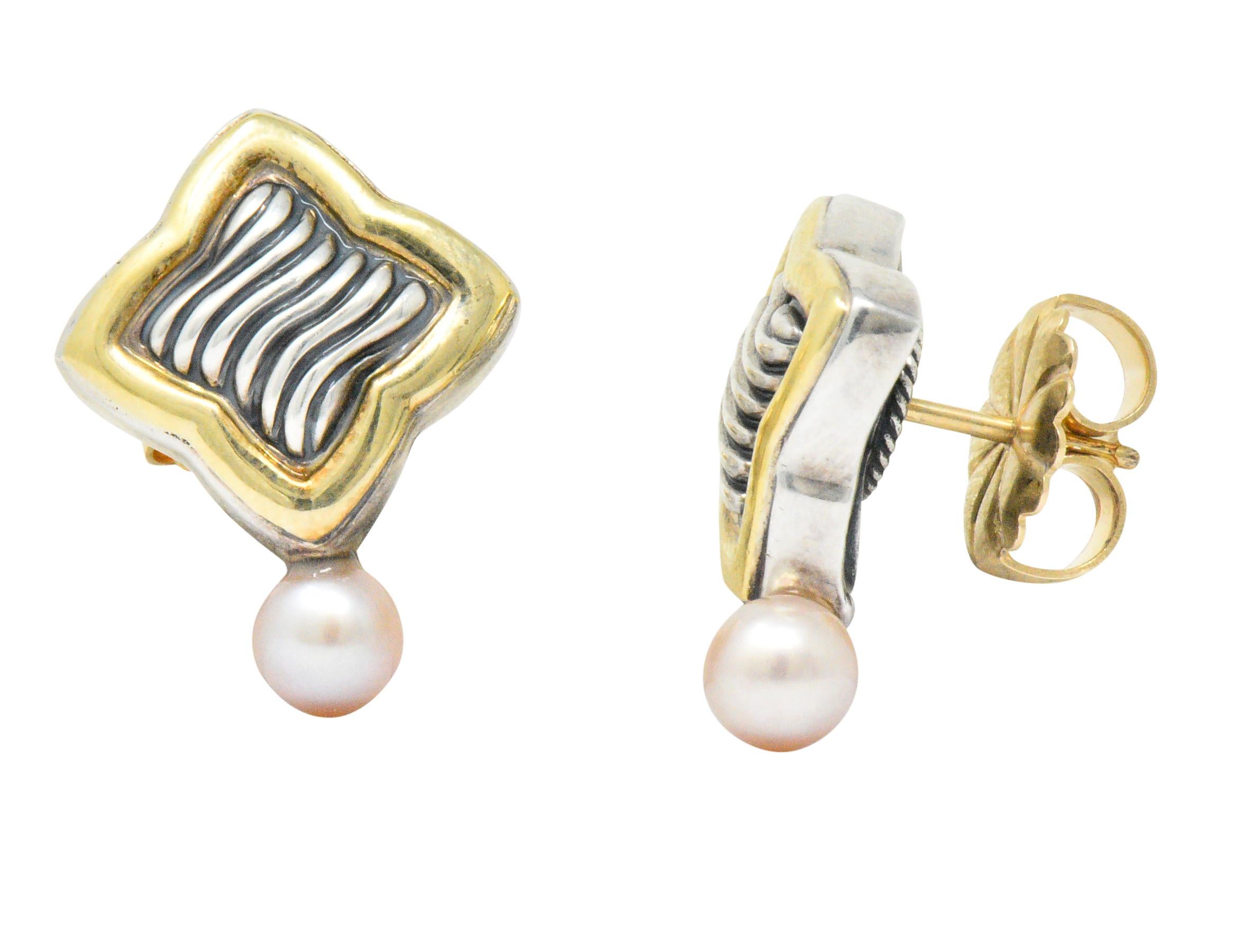 Earrings designed as a quatrefoil surmount with deeply ridged silver surrounded by high polished gold

Terminating as a 5.0 mm pearl, white in body color with strong rosé overtones and excellent luster

Completed by posts and friction backs

From