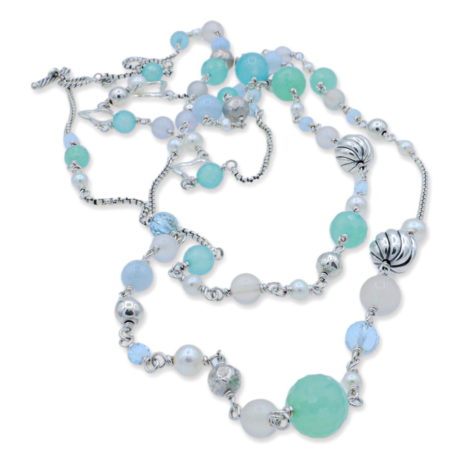 David Yurman extra long necklace finely crafted in sterling silver featuring several different colored beads and gems. The semi precious stones alternate the length of the necklace, accented by two quatrefoil enhancers hanging off a round cable link