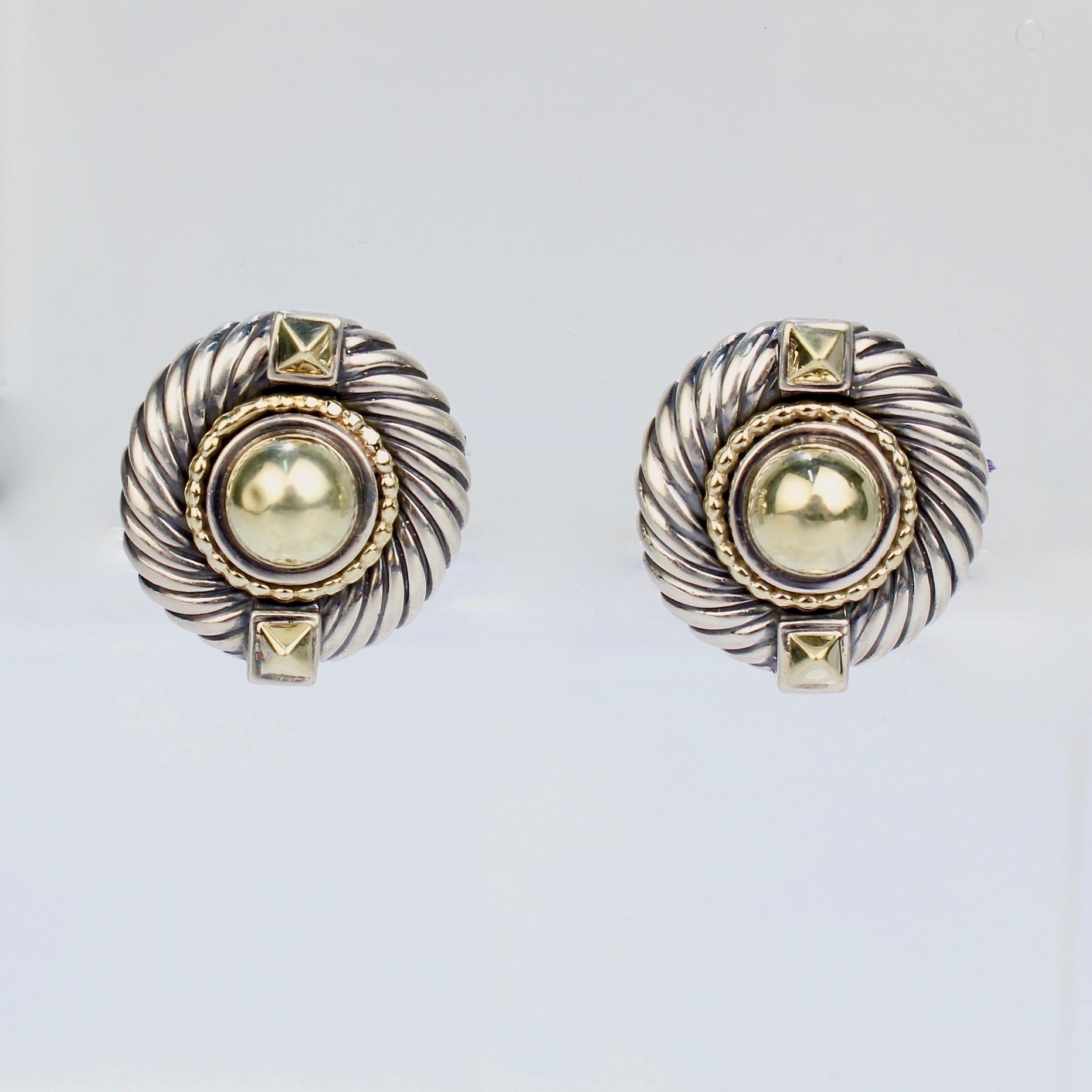 A wonderful pair of David Yurman Renaissance earrings.

Comprised of sterling silver and 14k gold. Each earring has a domed central gold cabochon flanked by two pyramid shaped buttons. The gold cabochons are framed in a beaded gold wire and Yurman's