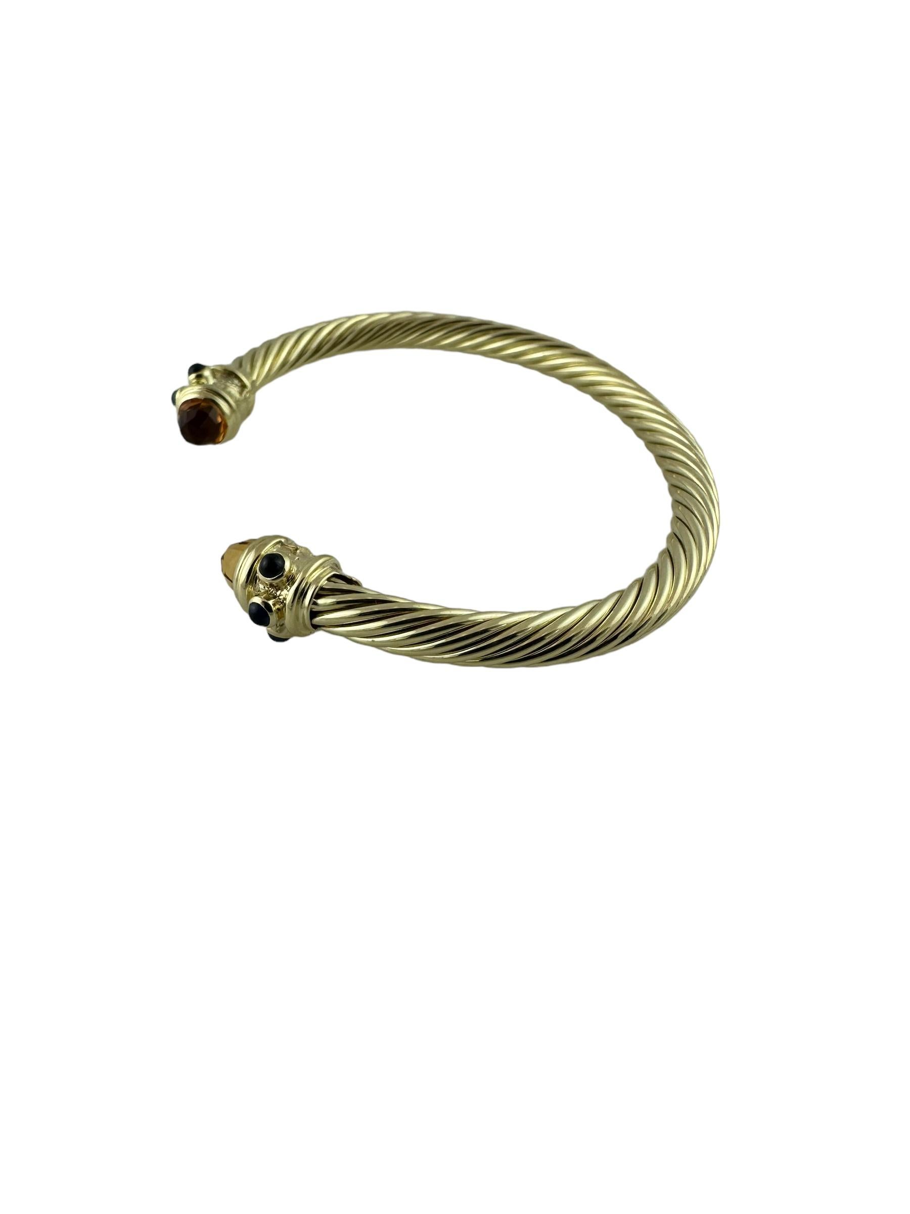 David Yurman Renaissance 14K Yellow Gold Citrine Sapphire Cable Cuff Bracelet

This beautiful cable cuff bracelet is from the David Yurman Renaissance collection and is set in 14K yellow gold

End caps are faceted citrine stones. Three cabochon blue