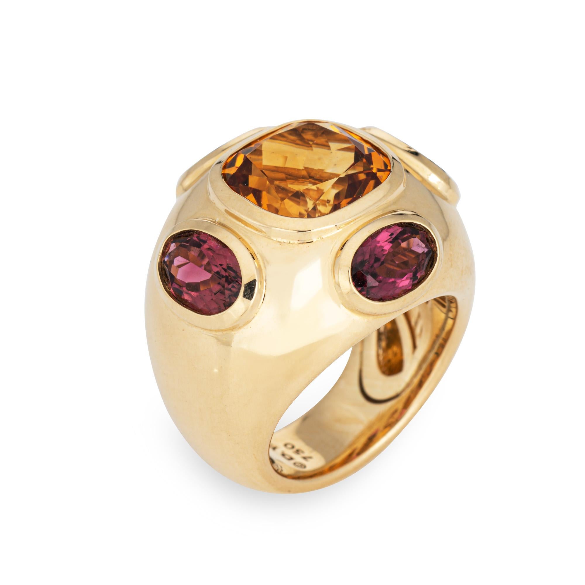 Estate David Yurman Renaissance ring crafted in 18 karat yellow.  

The out of production David Yurman ring is set with a center set citrine measuring 10mm. Rhodolite garnets measure 8mm x 5mm. The gemstones are in very good condition and free of