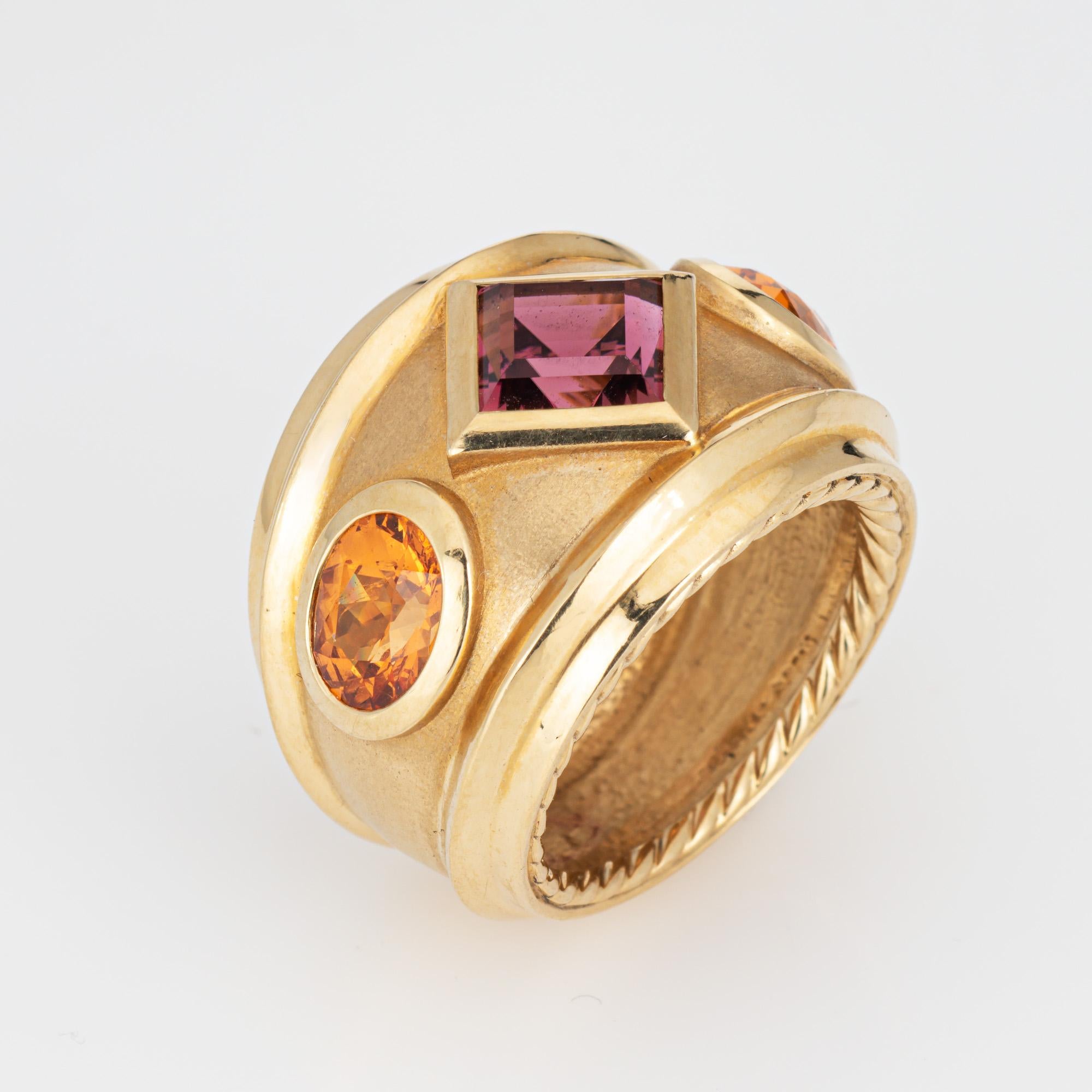 Estate David Yurman Renaissance ring crafted in 18 karat yellow.  

The out of production David Yurman ring is set with a center set Rhodolite garnet measuring 6mm. Two citrines measure 7mm x 5.5mm. The gemstones are in very good condition and free