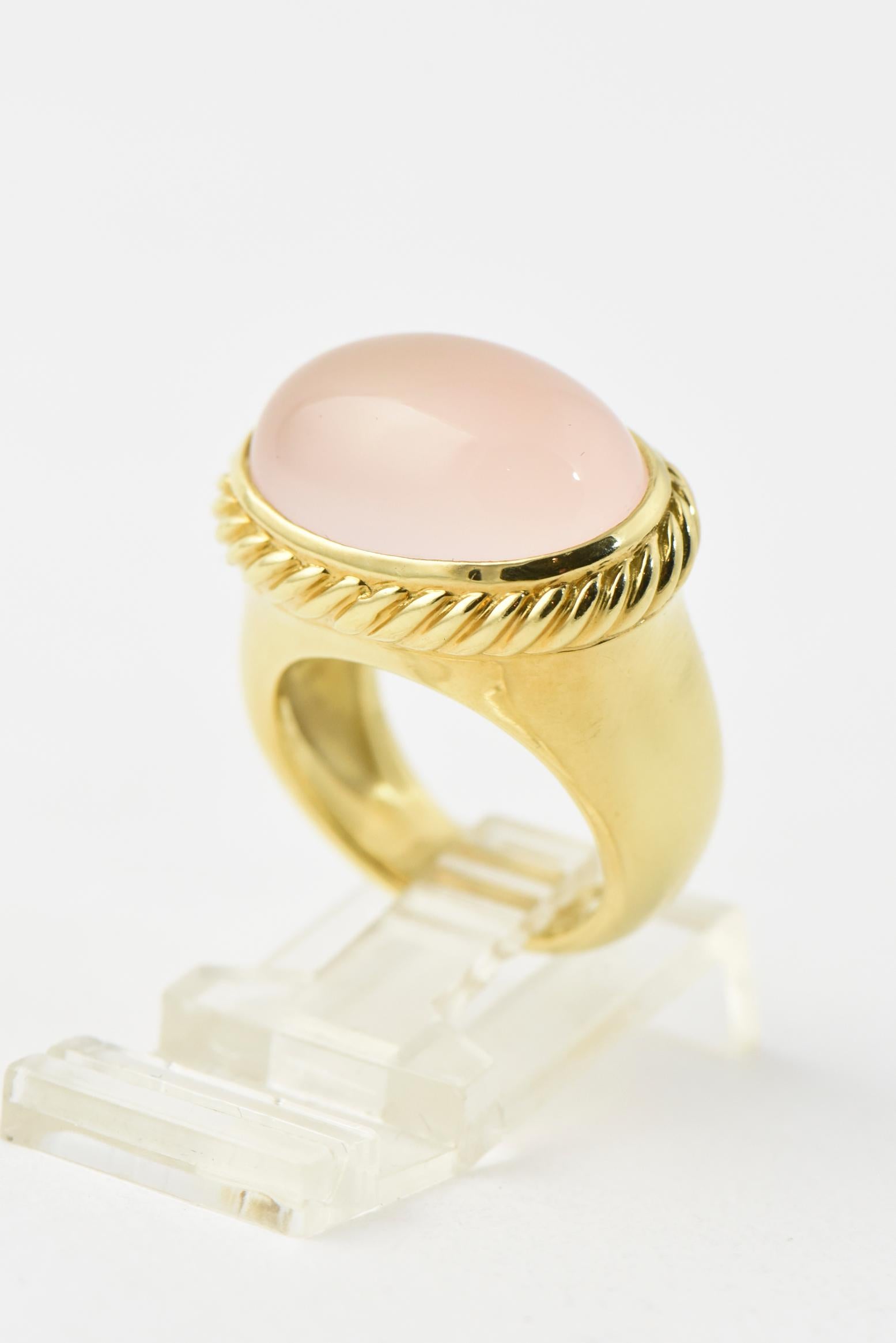 David Yurman 18k yellow gold east - west signature ring with cabochon rose quartz mounted in a cable frame. The band is solid gold with a smooth finish.  Marked 