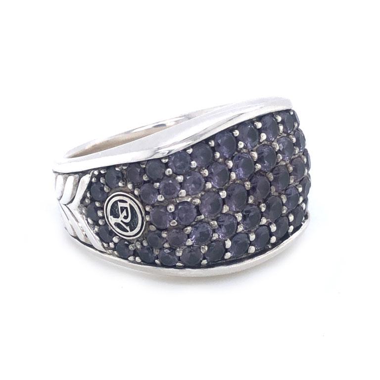 This designer ring features 64 round blue/purple color changing garnets on the front and shoulders of the ring. The ring shank is decorated with a chevron pattern. The ring is 17.7 mm wide at the top. The total weight is 25.1 grams. The ring is size