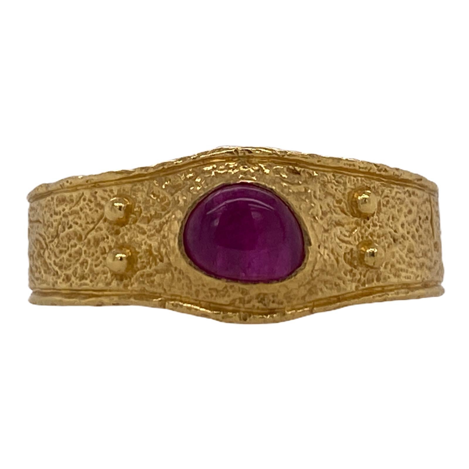 David Yurman 22 karat yellow gold textured band ring from the Shipwreck current collection. The band features a cabochon ruby gemstone. The ring is currently size 10.5 (can be sized), and weighs: 12.3 grams. Signed DY 916. David Yurman jewelry pouch