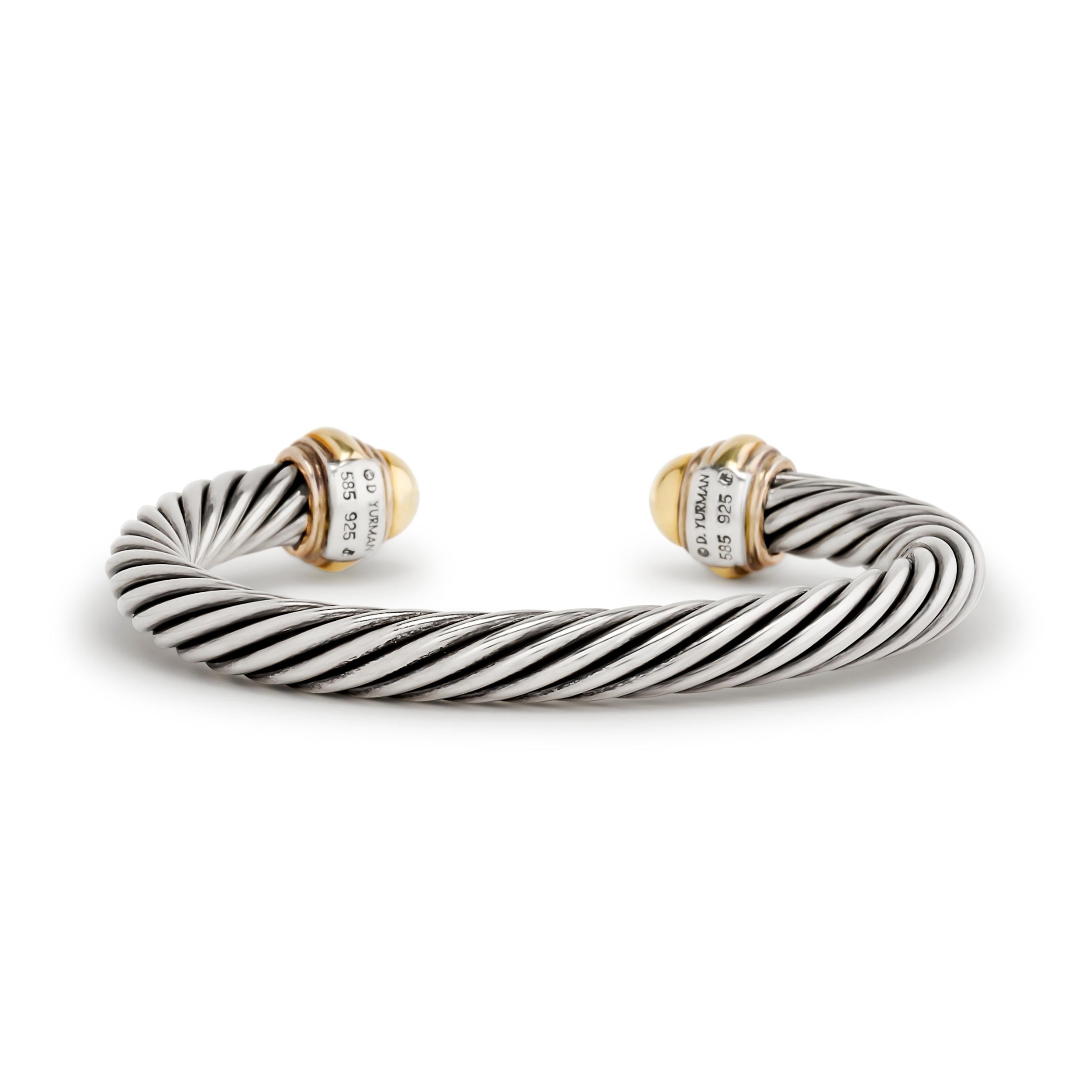A classic David Yurman cuff bracelet featuring the iconic cable design in silver and 14K yellow gold.

Signed 