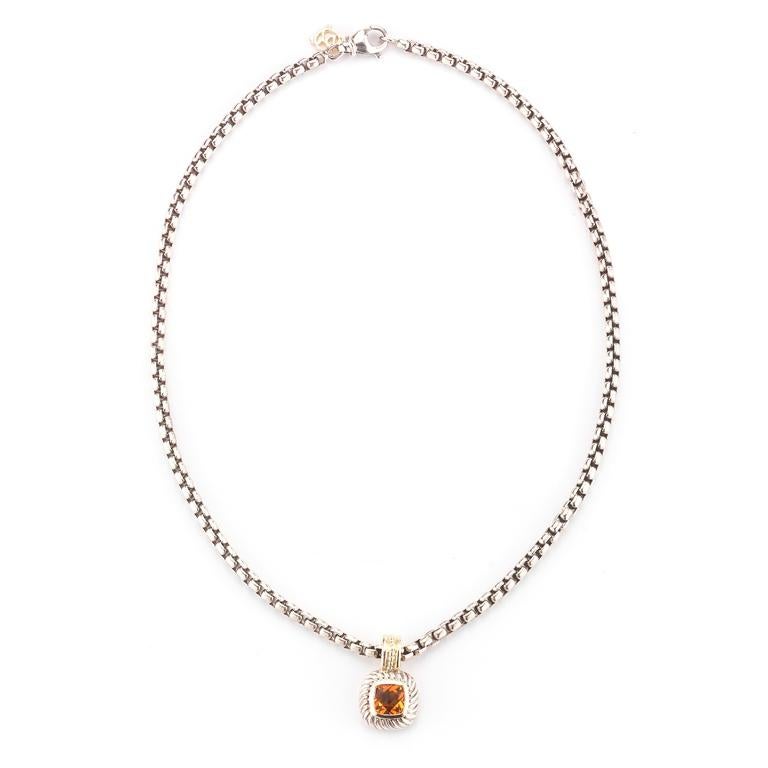 A 7mm cushion citrine is mounted in sterling silver accented with 14 karat yellow gold in a cable Albion Collection pendant suspended on a sterling silver chain 16 inches in length. Stamped D. Yurman.