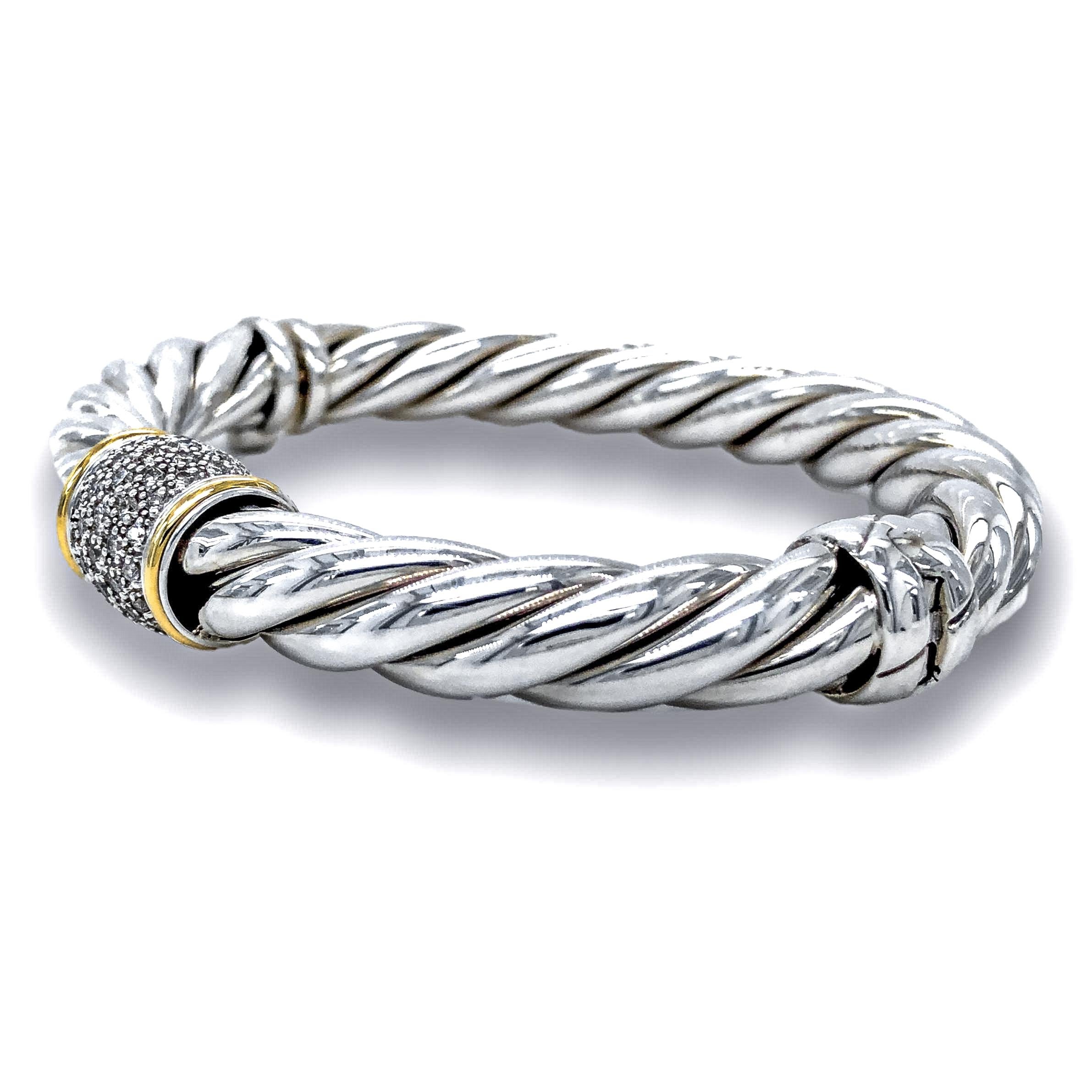Vintage David Yurman Wide two tone bangle bracelet from the cable classics collection finely crafted in sterling silver featuring a station of pave set round brilliant cut diamonds weighing 0.25 cts total weight approximately inside 2 strip details