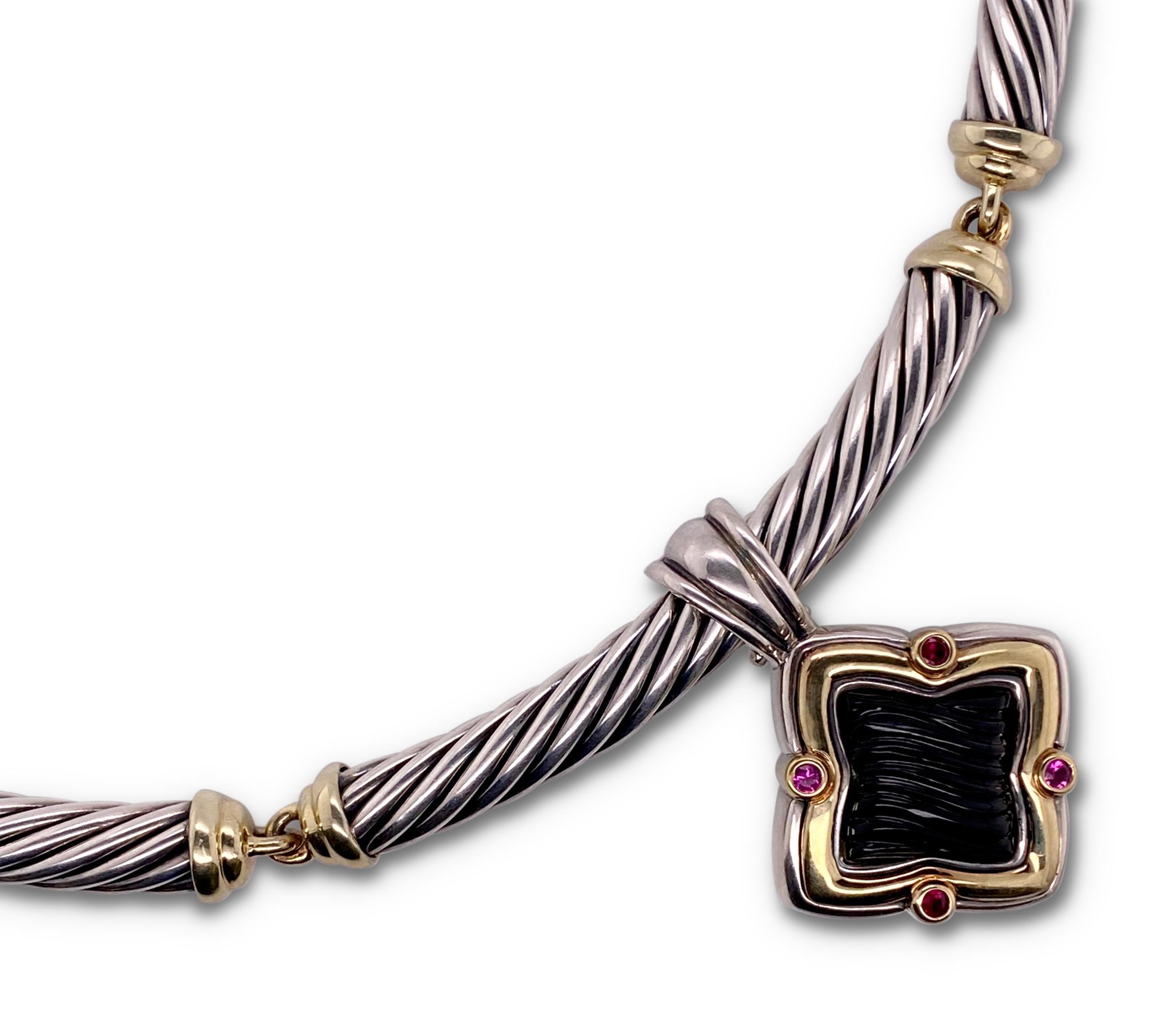 Authentic David Yurman 6mm cable choker necklace crafted in sterling silver with 14 karat yellow gold.  Necklace features a quatrefoil shaped pendant crafted in 18 karat yellow gold and sterling silver with a large textured onyx center and 4