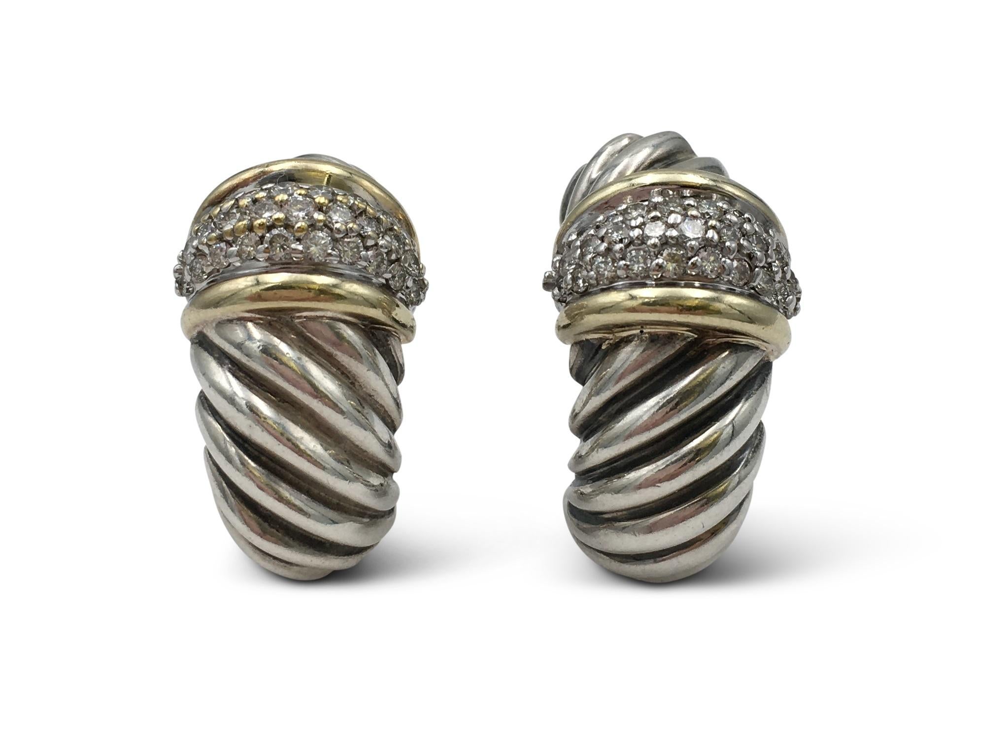 Authentic David Yurman silver and 18 karat yellow gold earrings from the Cable Collection. Set with an estimated 1.15 carats of round brilliant cut diamonds (F-G color, VS-SI clarity). Signed DY, 925, 750. The earrings are not presented with