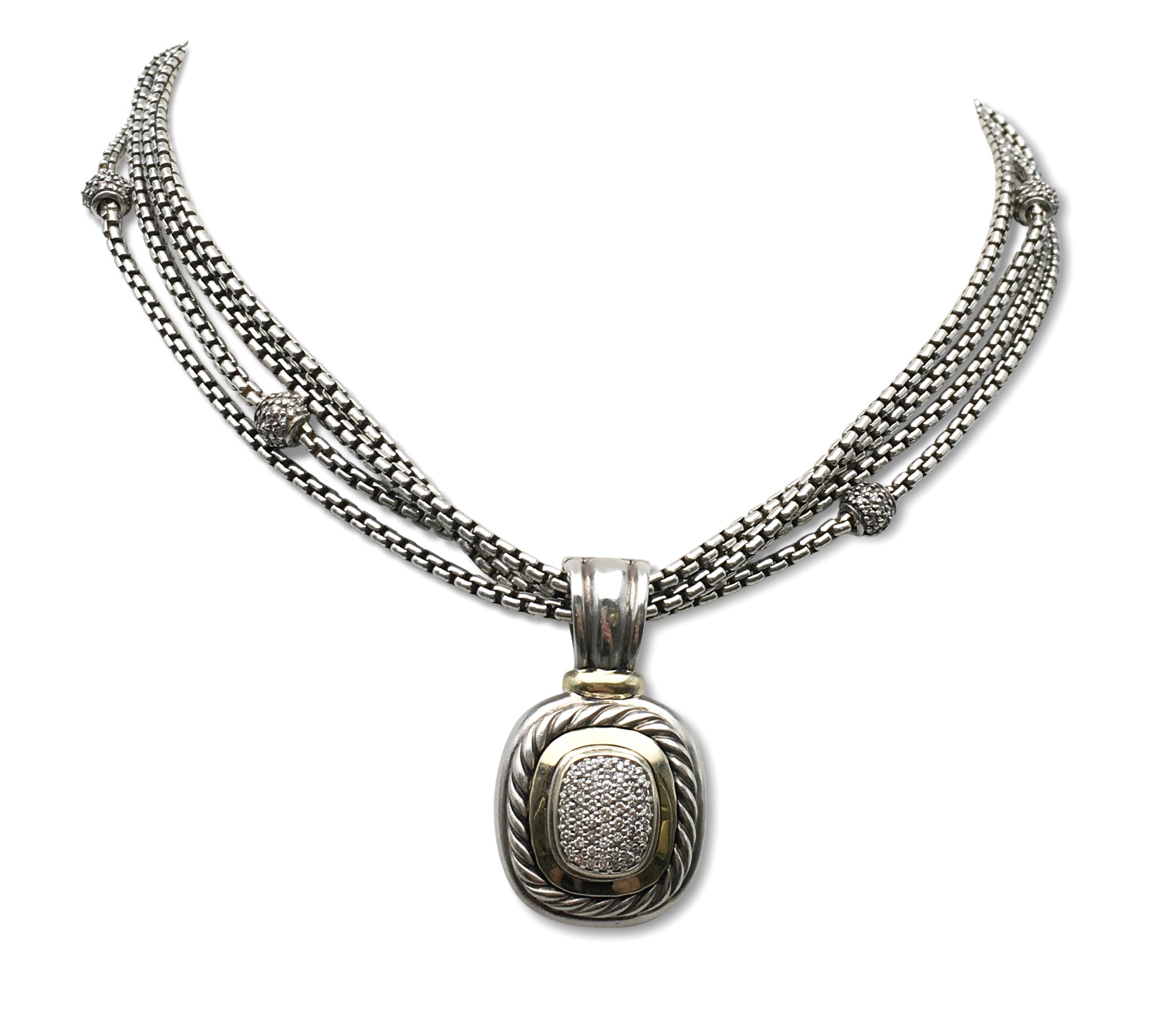 Authentic David Yurman necklace crafted in sterling silver and 18 karat yellow gold.  Featuring a silver and 18 karat yellow gold Abion enhancer pendant with approximately 50 diamonds weighing an estimated 1cctw.  The pendant measures 25mm x 22mm