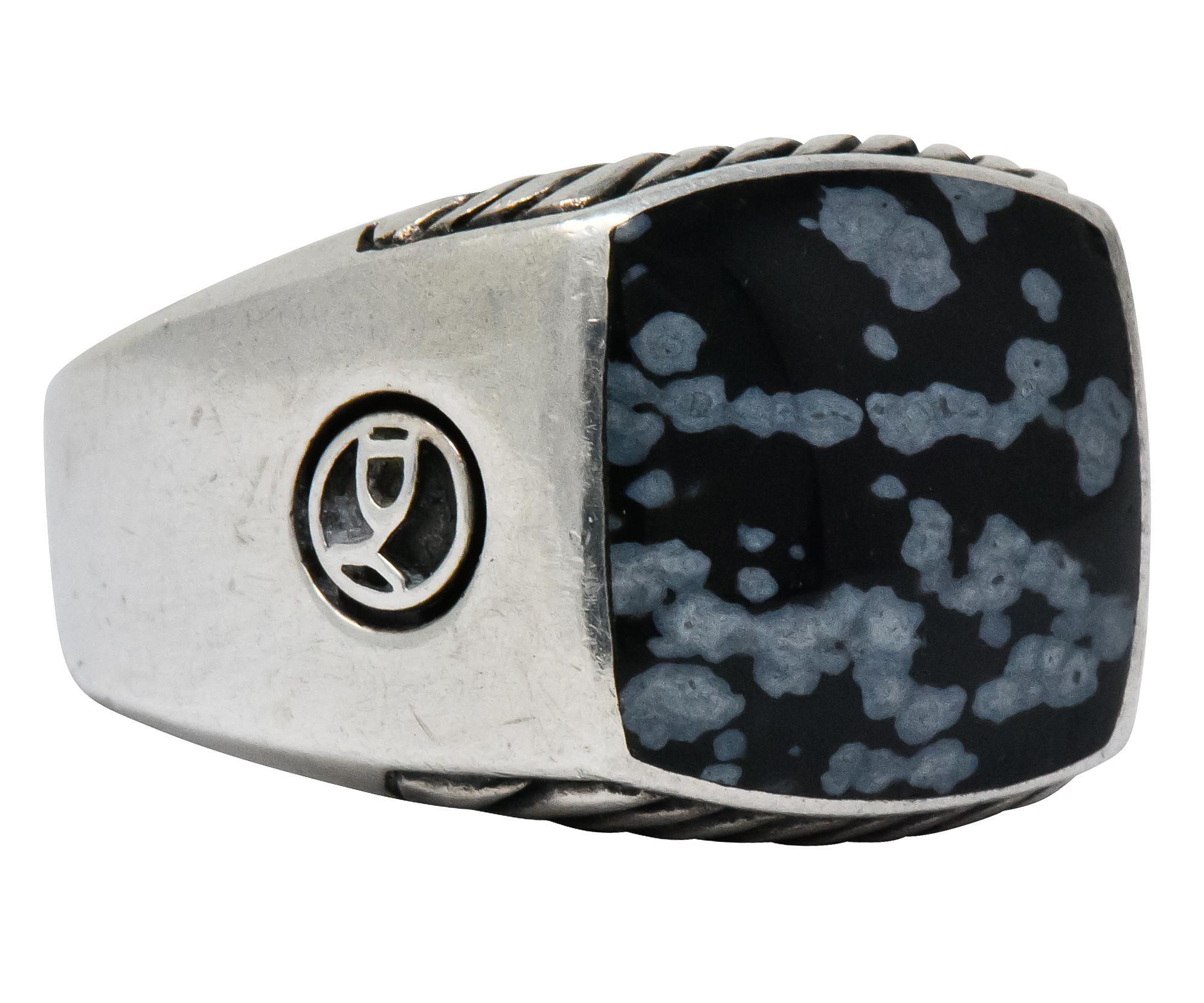 Centering an inlaid square slice of snowflake obsidian, opaque black background with white mottling and good polish

Accompanied by ribbed silver pattern on profile faces

From David Yurman's Exotic Stone collection

Silver maker's mark on