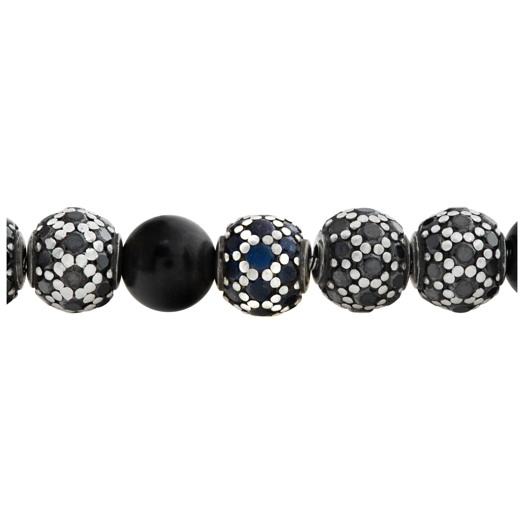 David Yurman Spiritual Bead bracelet with 6 mm black onyx beads, approx. 6.82 cts black diamonds and aqpprox. 3.41 cts blue sapphires in 18k gold. 7.25 inch length. Comes with David Yurman appraisal.