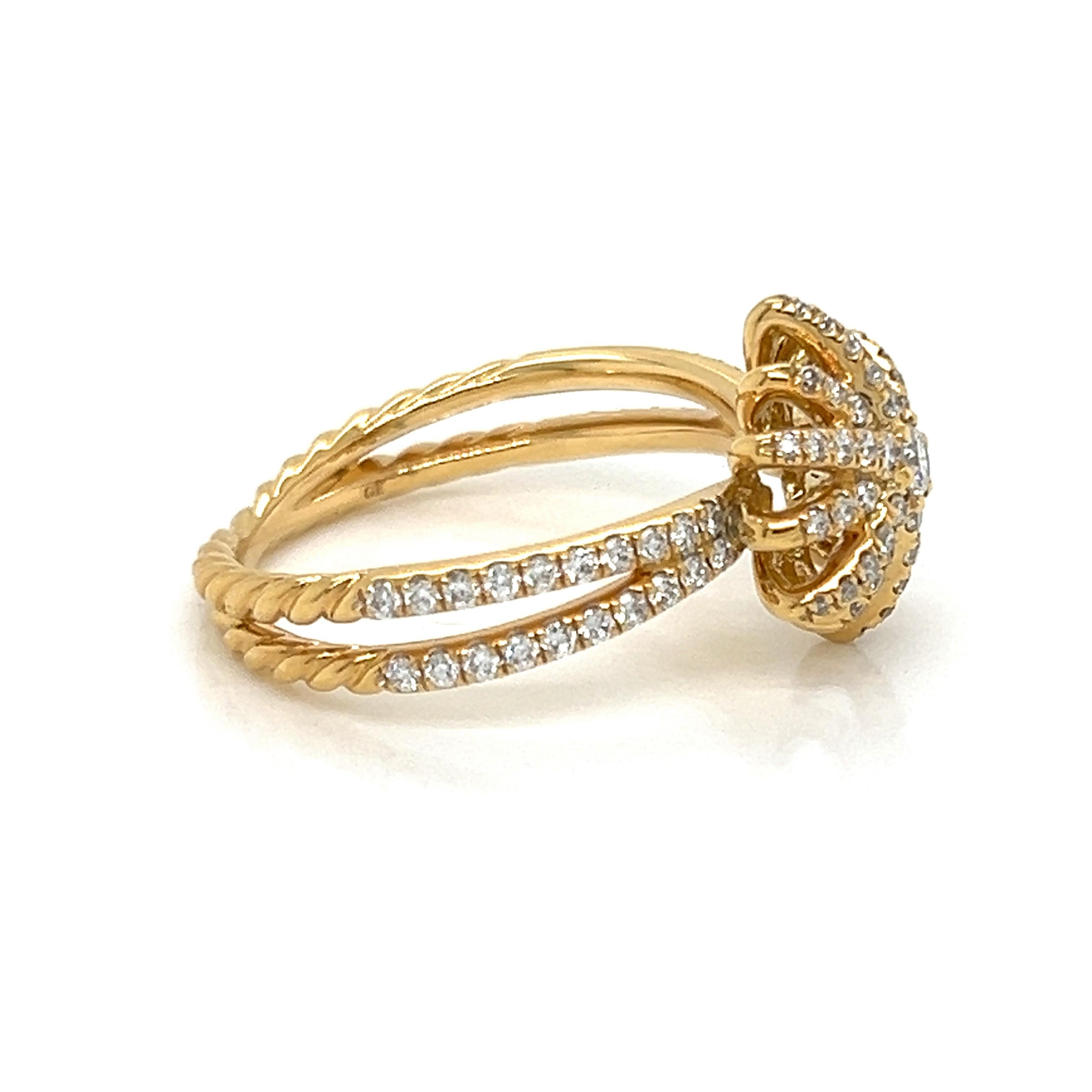 This stunning ring is by David Yurman from the Starburst Collection. It is crafted from 18k yellow gold with a dome shaped starburst at the top of the ring with split shank all decorated with sparkling diamonds.  The star motif design was inspired