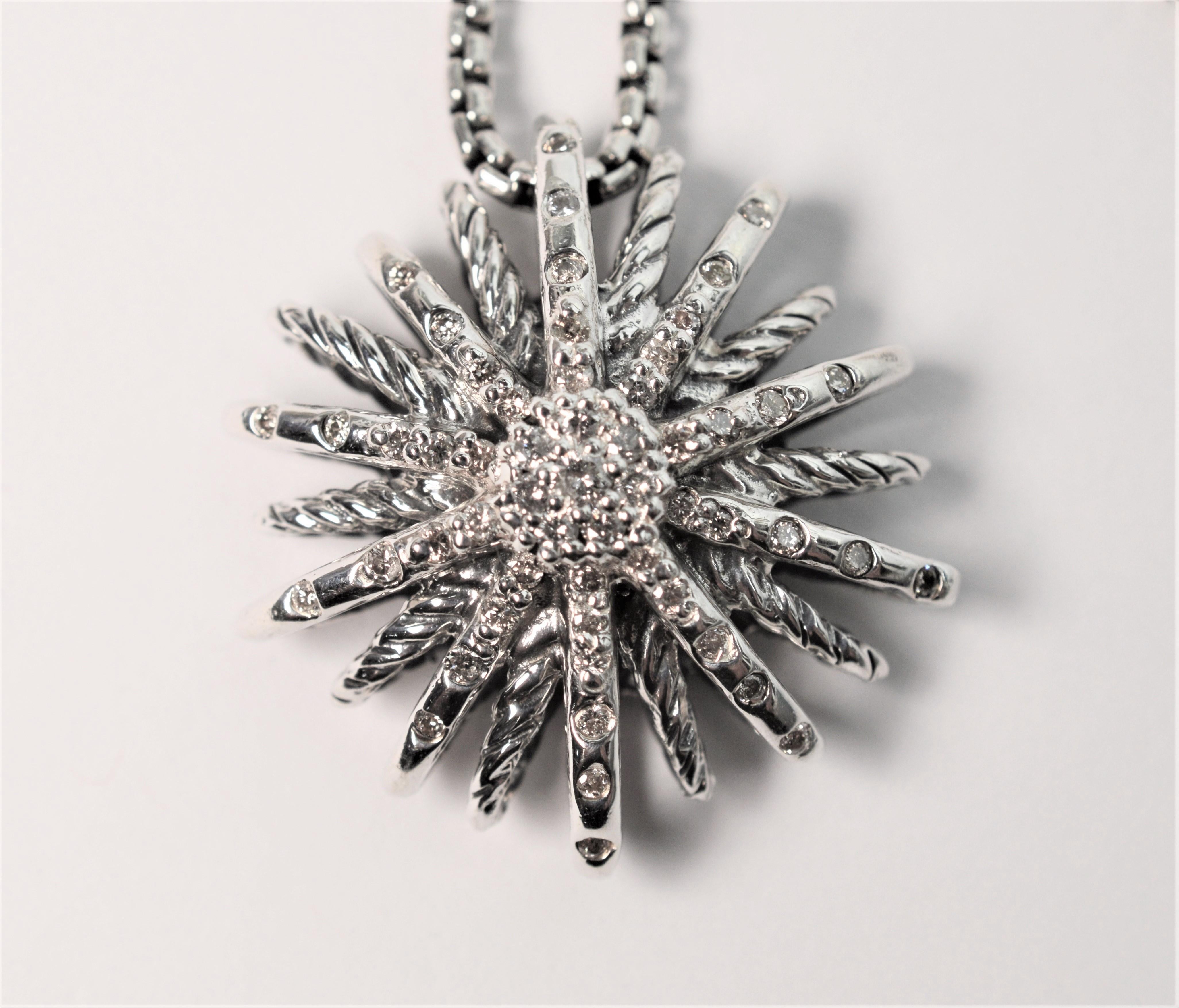 Enjoy this versatile and timeless pendant design said to be inspired by fireworks created by well known jewelry designer David Yurman. Crafted in sterling silver, this three dimensional 26mm starburst pendant sparkles with over .50 carat of pave