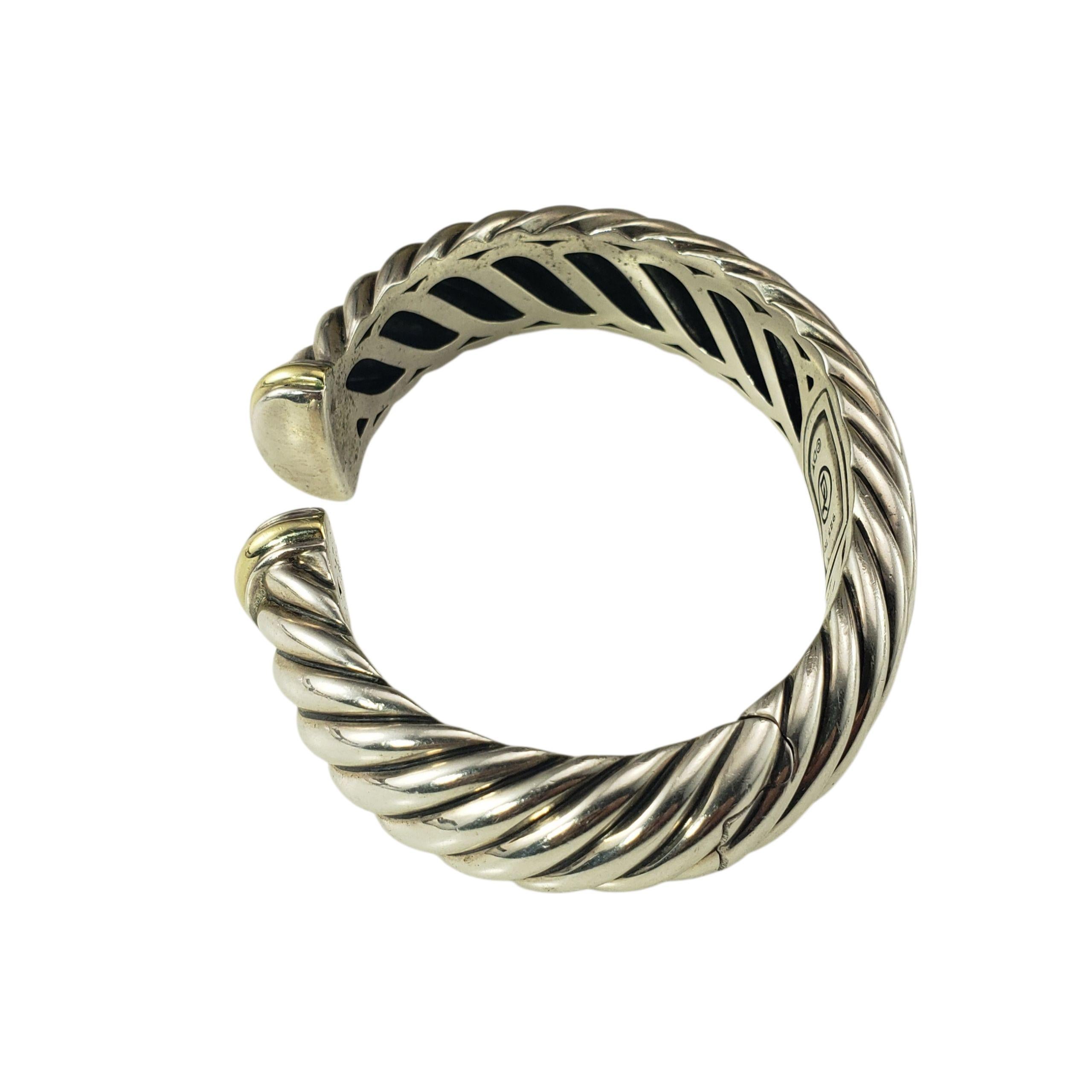David Yurman Sterling Silver and 18K Yellow Gold Sculpted Cable Hinged Cuff Bracelet-

This stunning cuff bracelet by David Yurman is crafted in sterling silver with 18K yellow gold accents, adding a touch of elegance. The hinged closure ensures a