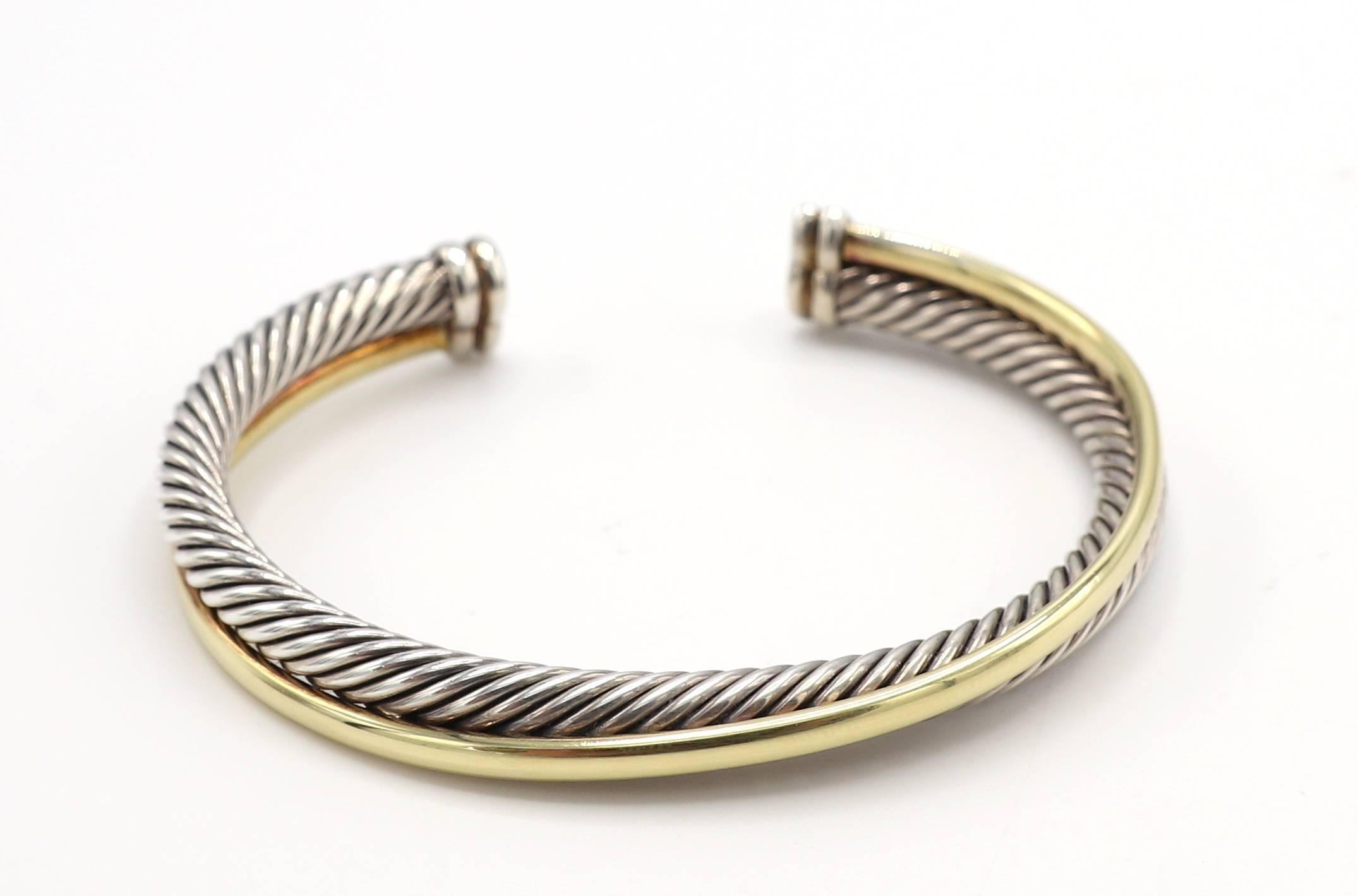 David Yurman Sterling & Gold Cable Crossover Cuff Bangle Bracelet 
Metal: Sterling silver & 18 karat yellow gold
Weight: 35.34 grams
Width: 5-8mm
Signed: D.Y. 750 925
Retail: $1,250

