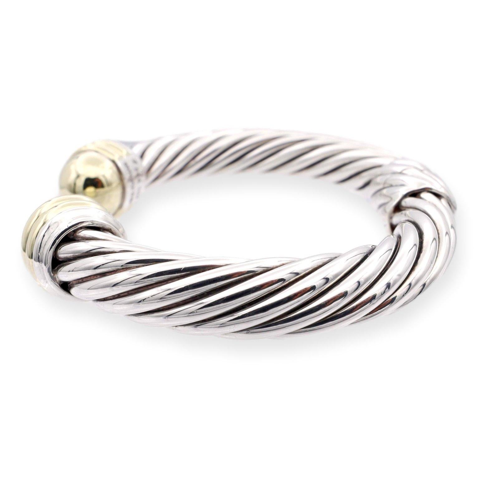 Vintage David Yurman open-cuff bracelet from the the cable classics collection finely crafted in sterling silver featuring two large dome caps at each end in 14 karat yellow gold with a smooth finish and hinged closure for easy slip-on. Bracelet