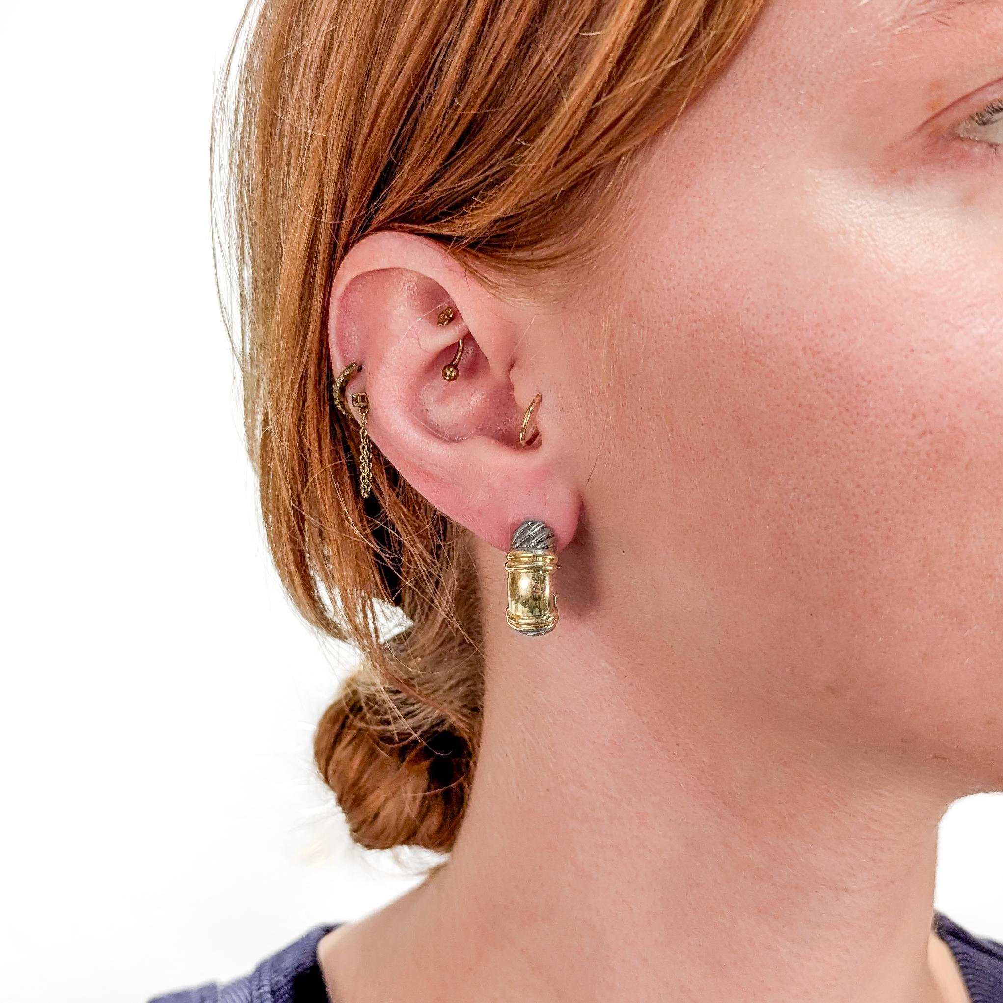 A fine signed pair of designer silver & gold earrings.

By David Yurman.

In sterling silver with 14 karat yellow gold elements.

Each with gold posts and silver omega clip closures.

Marked to the interior of each.

Simply wonderful Yurman