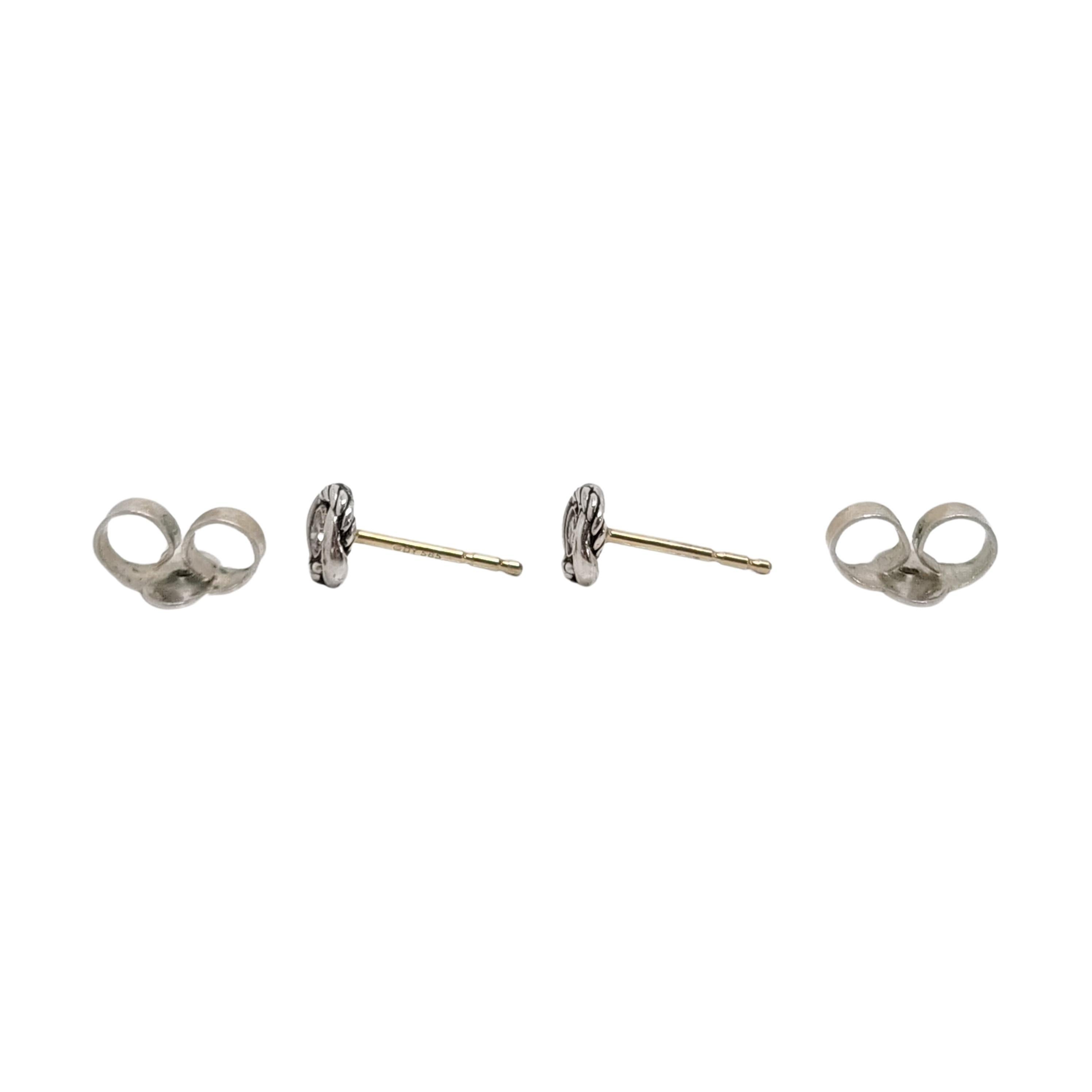 David Yurman sterling silver 14K yellow gold posts Infinity Diamond Stud Earrings.

Sterling silver infinity knot design surrounds small round diamonds on the small stud earrings by David Yurman. 14K yellow gold posts.

Measures approx 6.8mm x 6.8mm
