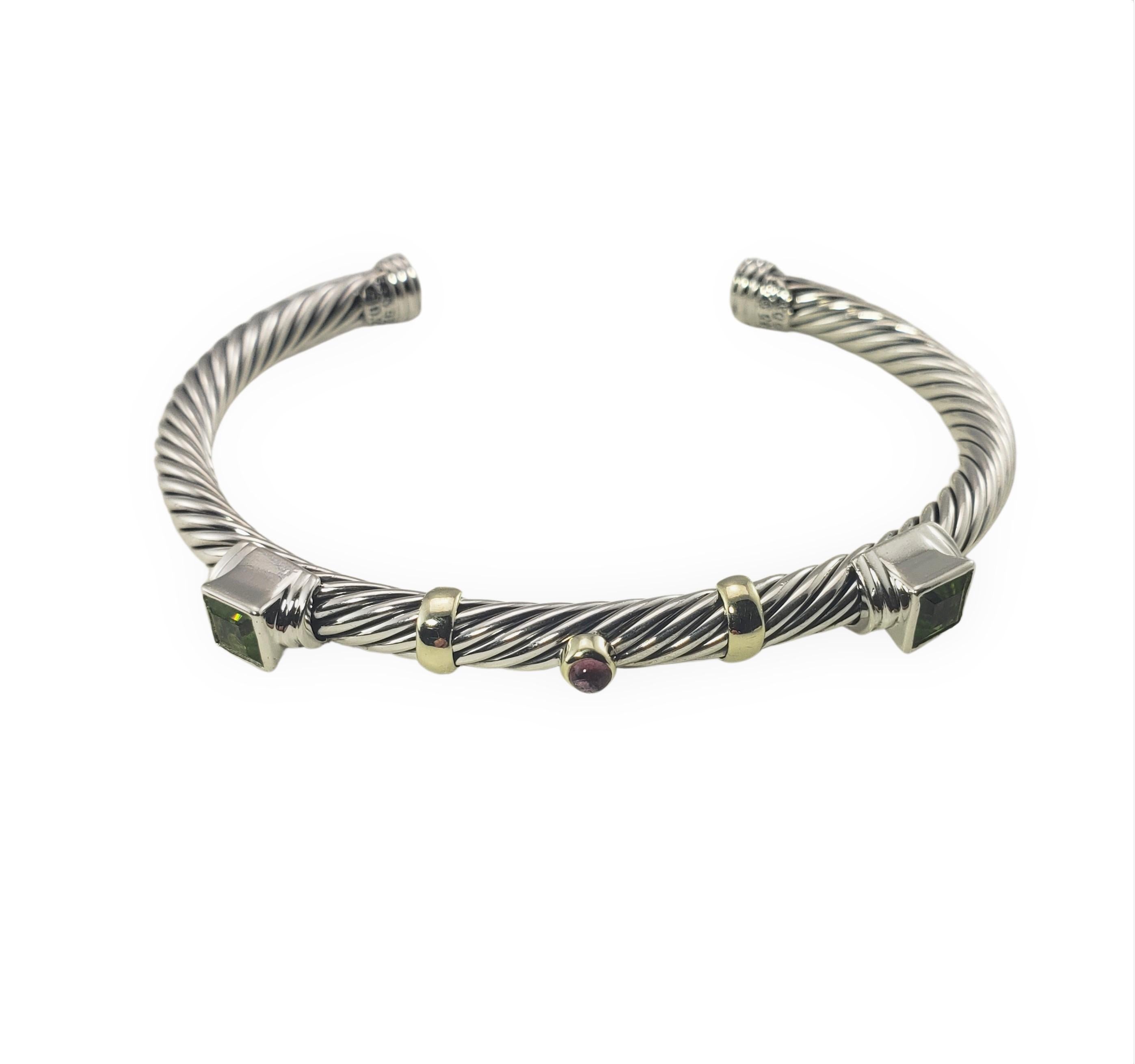 David Yurman Sterling Silver and 14 Karat Yellow Gold Peridot and Garnet Cuff Bracelet-

This lovely bracelet features two square peridot stones (6 mm x 6 mm each) and one cabochon amethyst (4 mm) set in beautifully detailed sterling silver and 14K