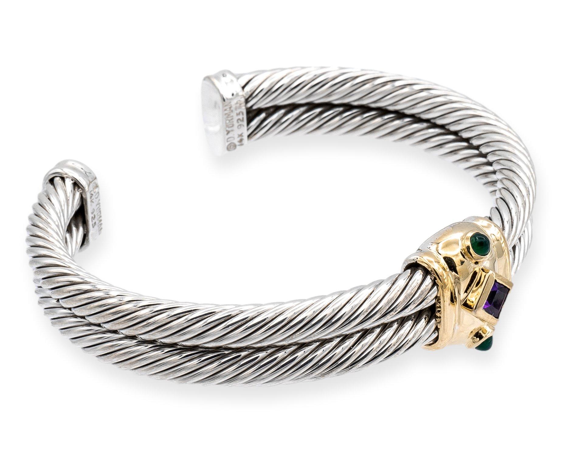David Yurman is a well-known luxury jewelry brand known for its artistic designs and high-quality materials. This Renaissance style bracelet is made from a combination of sterling silver and 14K yellow gold, and features a double row cable design