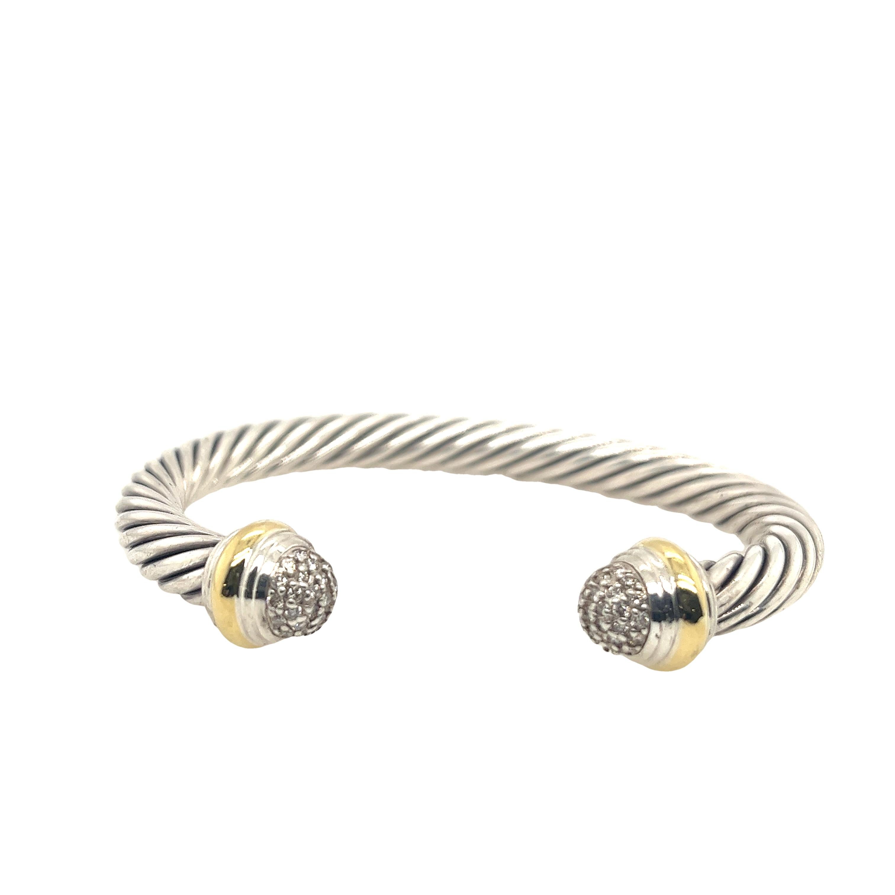 Introducing the exquisite David Yurman sterling silver and 18ct yellow gold  cable bangle with diamond end caps, a true masterpiece that combines elegance and sophistication.
Sterling silver with 18ct yellow gold diamond end caps
46 round brilliant