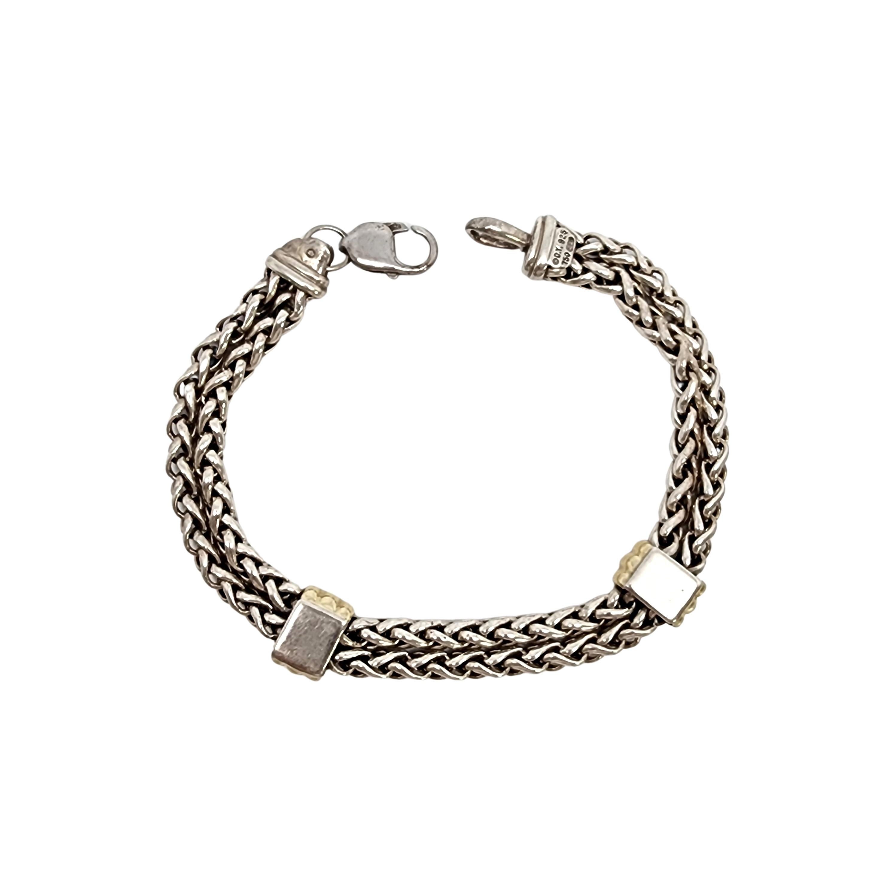 Sterling silver double wheat strand 18K yellow gold plated station men's bracelet by David Yurman.

Double strand wheat chains with 2 yellow gold plated accented stations. Lobster claw clasp.

**The clasp appears to have had a loop added to it most