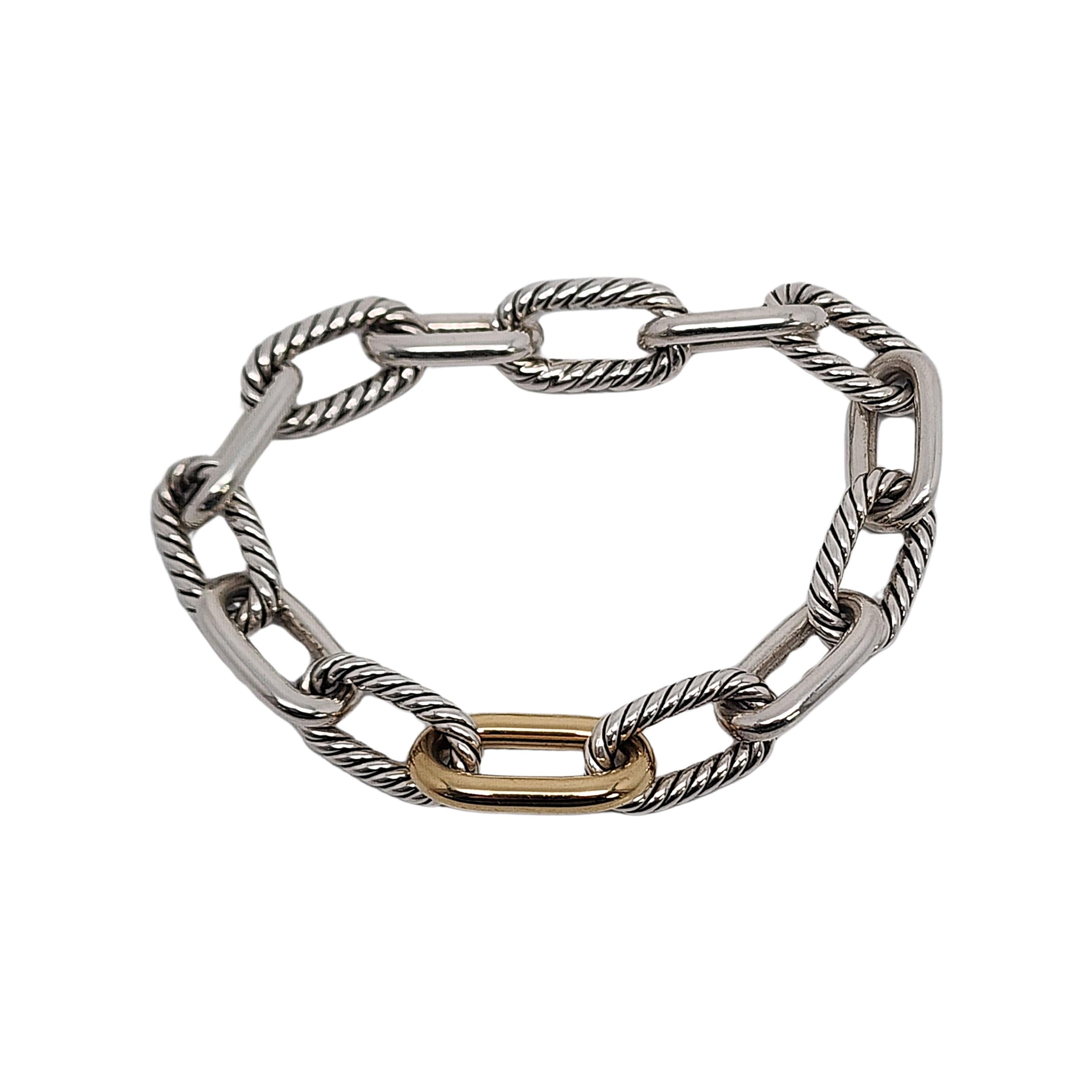 Sterling silver and 18K yellow gold plated oval link bracelet by David Yurman, with box and pouch.

This 11mm link bracelet features alternating textured and smooth sterling silver oval links and one smooth gold plated oval link at its center. The