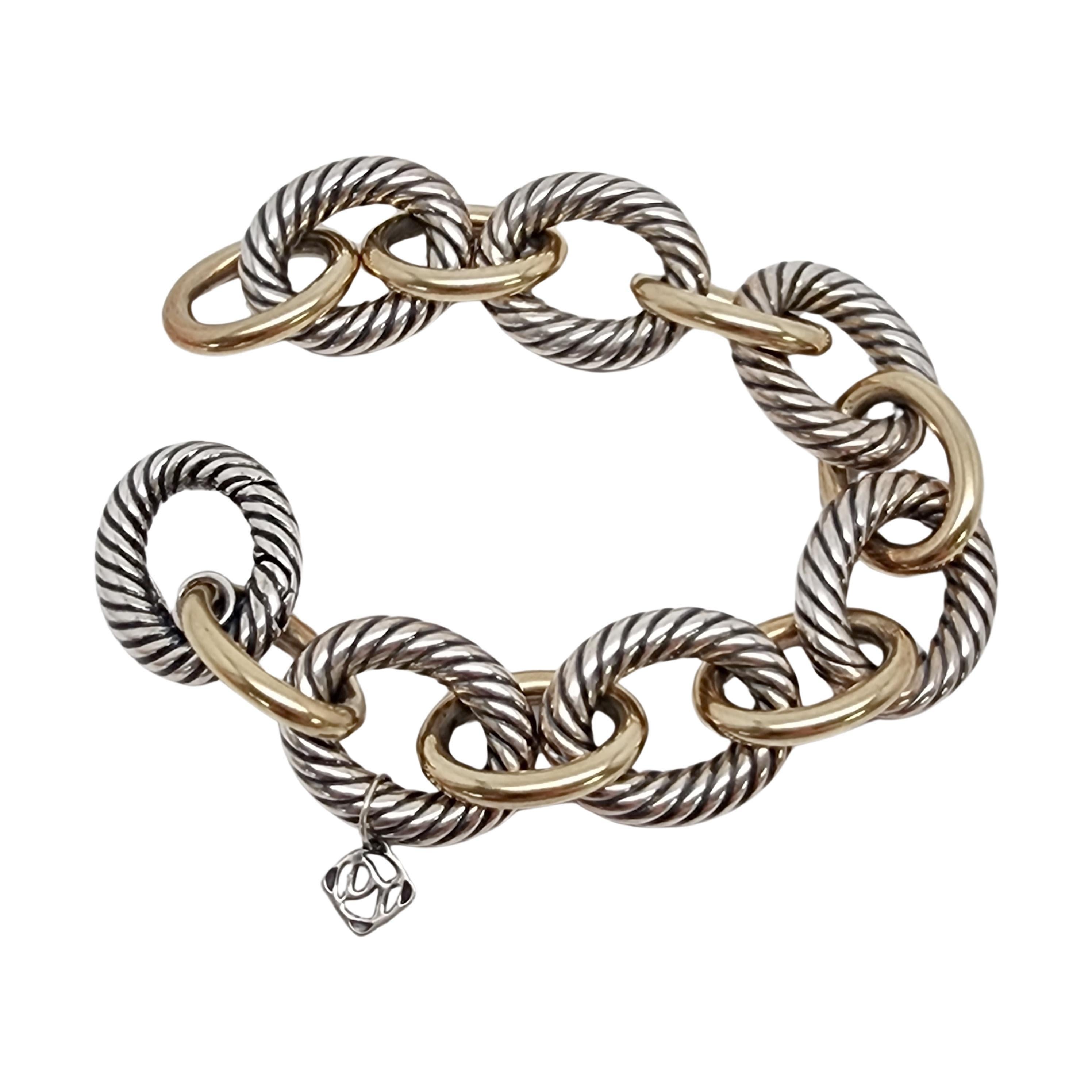 Sterling silver and 18K yellow gold plated oval link bracelet by David Yurman.

This large 18mm link bracelet features textured sterling silver oval links alternating with smooth gold plated oval links. The last link is a hidden clasp. DY tag
