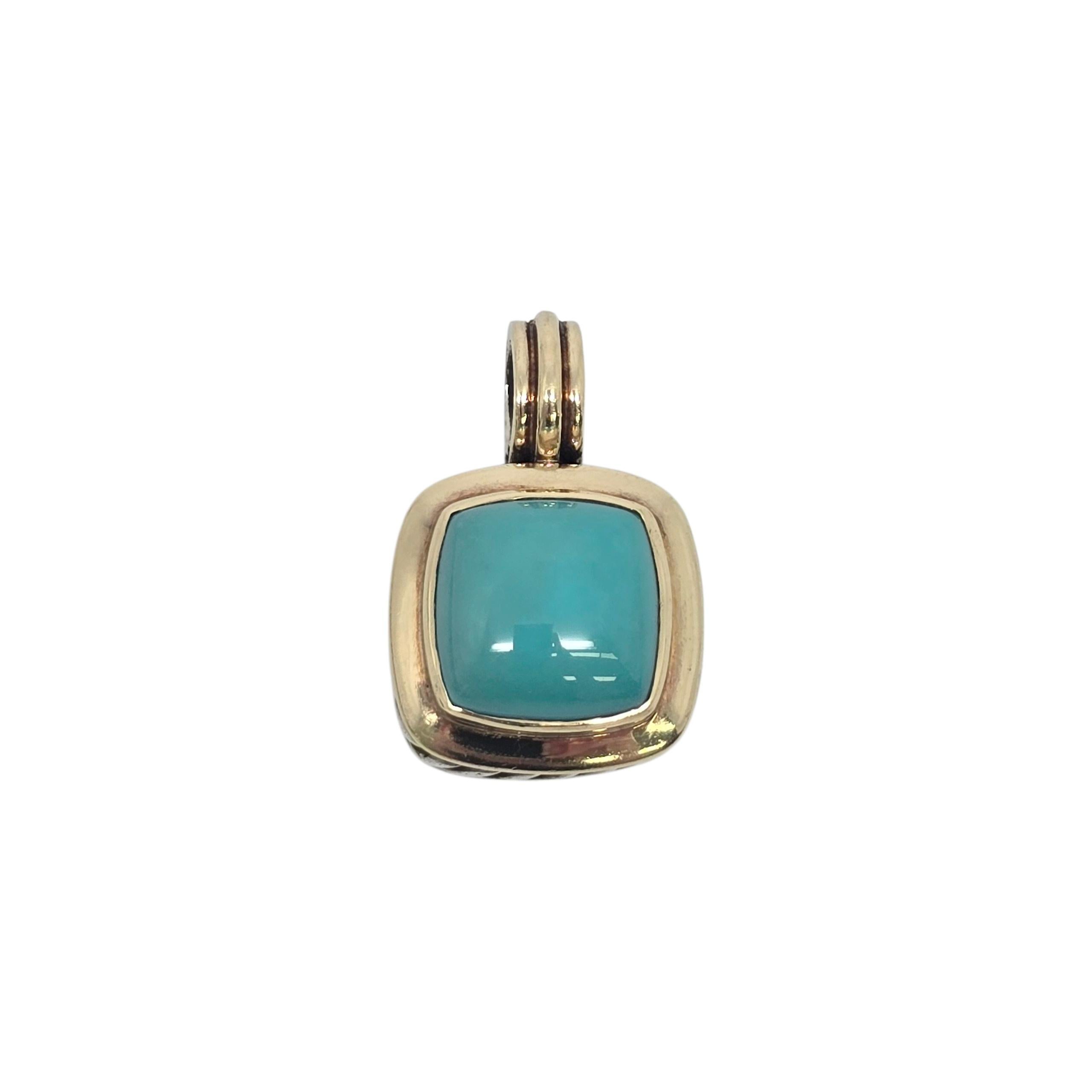 David Yurman sterling silver 18K yellow gold accent turquoise Albion pendant.

David Yurman's iconic Albion design pendant featuring a reconstituted turquoise stone bezel set in a gold accent bezel, with silver twist design around the
