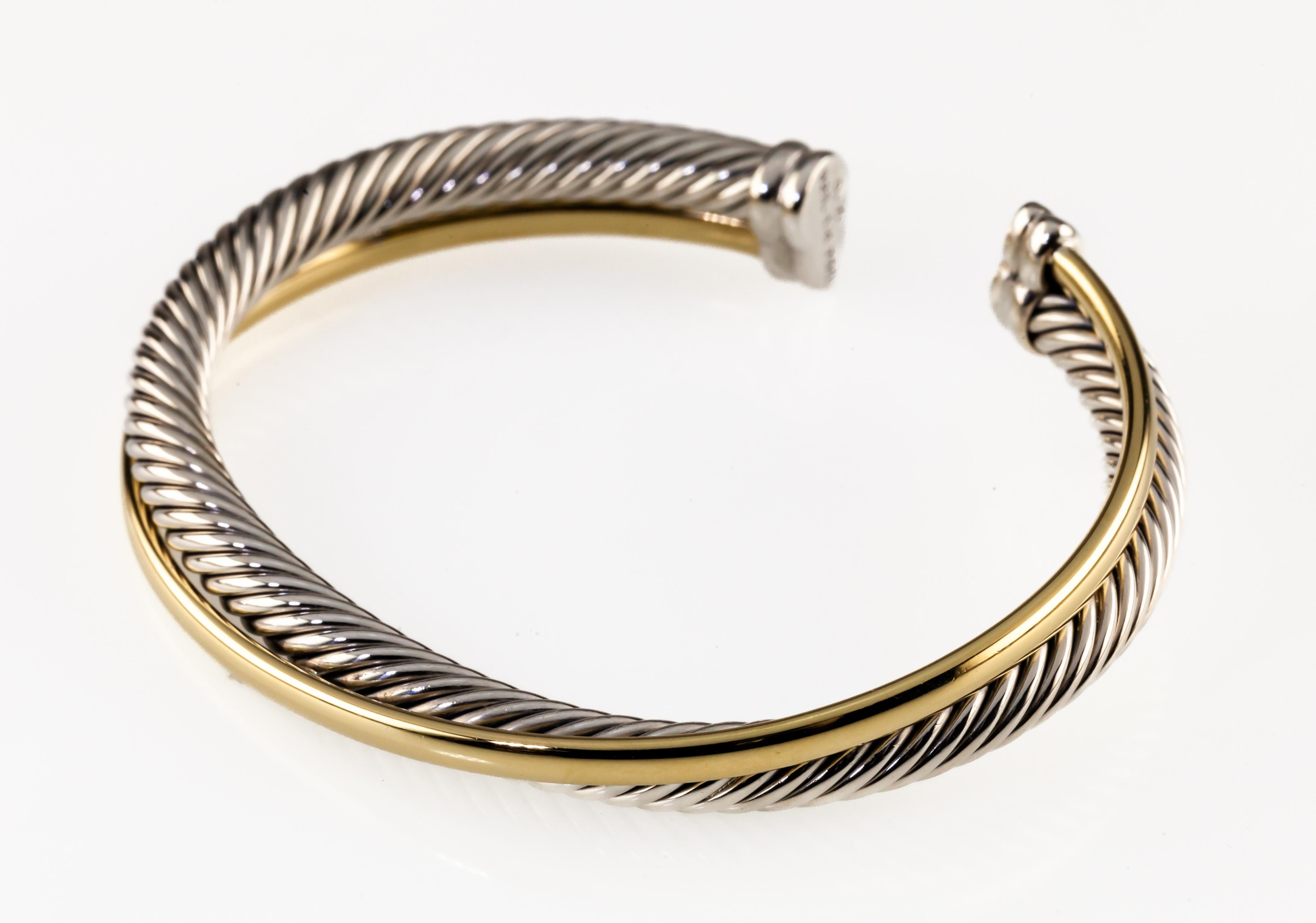 David Yurman Sterling Silver 18k Yellow Gold Cable Crossover Cuff Bracelet

Gorgeous Crossover Cuff Bracelet by David Yurman
Features 5 mm Cable Sterling Silver Band w/ 18k Yellow Gold Crossover (1/4)
Total Length of Cuff = 5.5