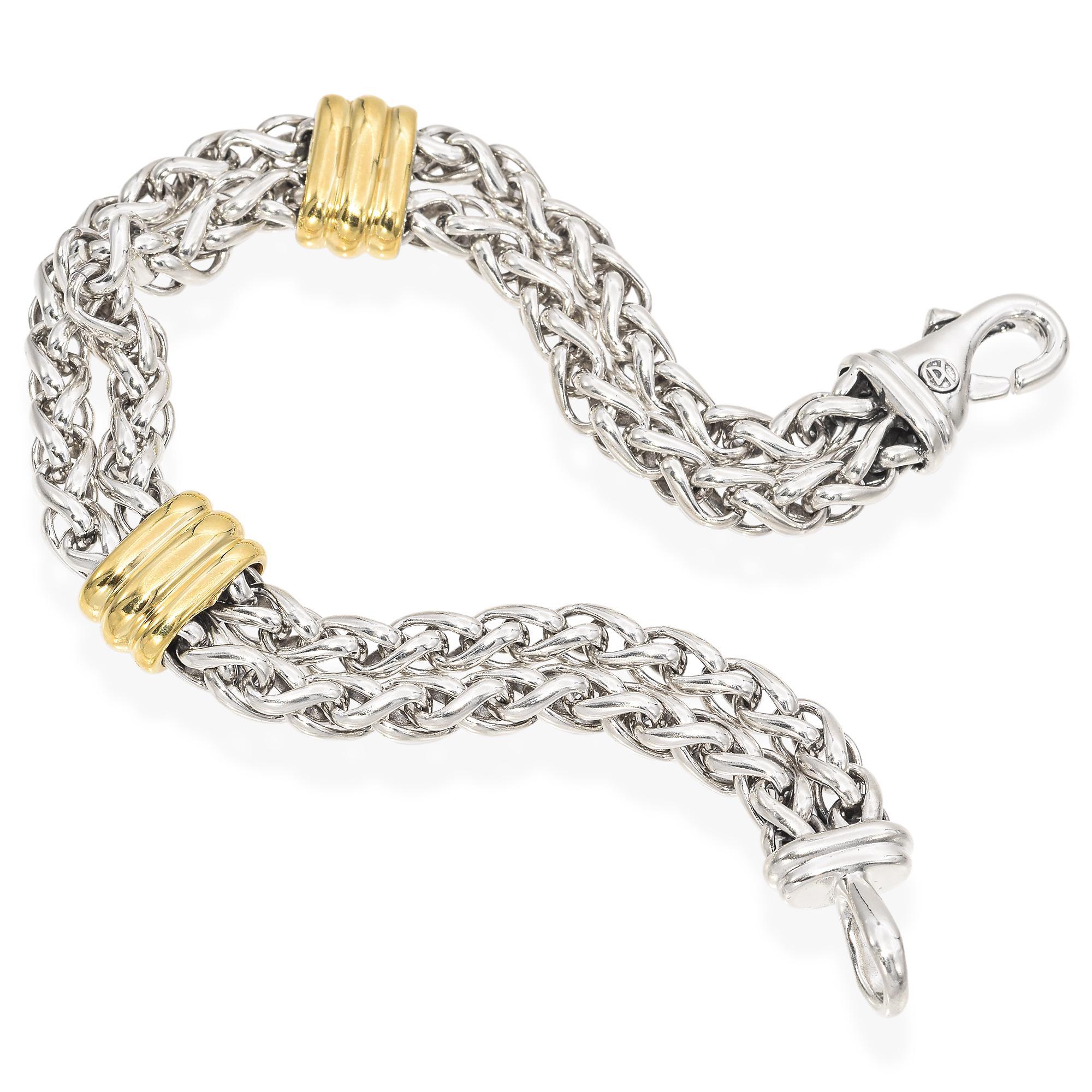 This exquisite chain bracelet by David Yurman is crafted from sterling silver, featuring two rows of signature woven design. The bracelet is accentuated with two 18k gold stations, adding a touch of elegance and contrast to the piece. The clasp is