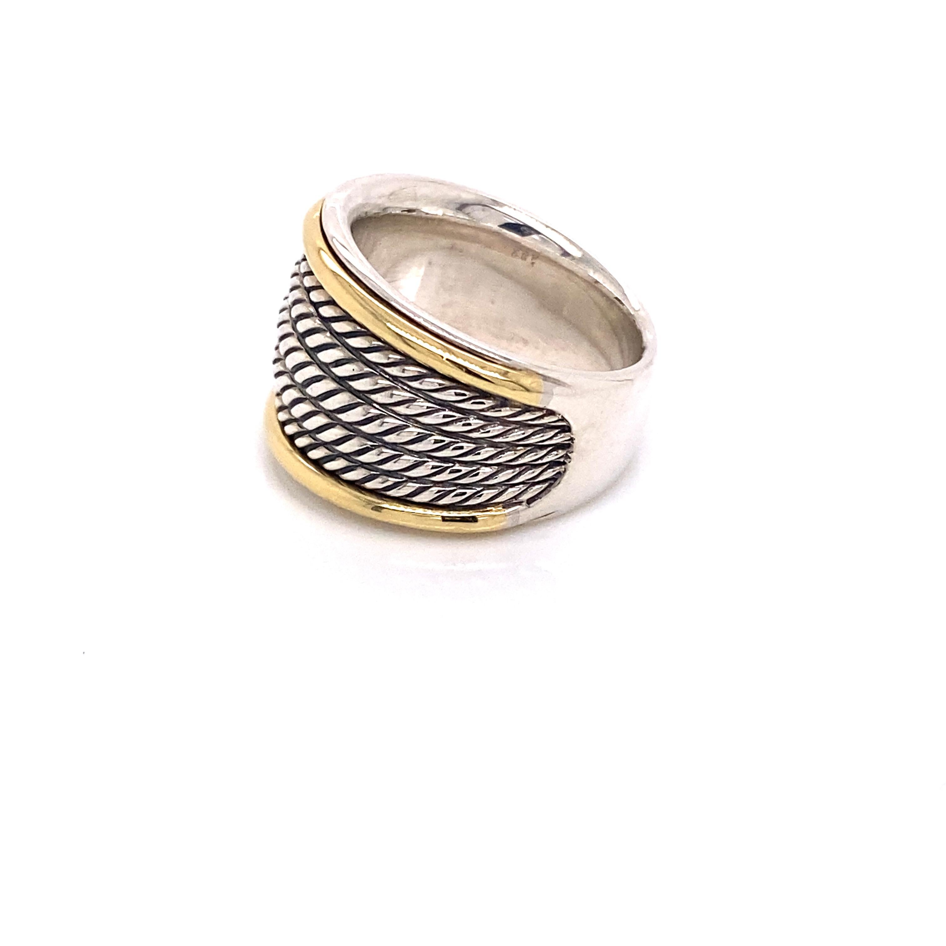 This classic David Yuman ring features sterling silver cable bands that fan out encompassed with 18 karat yellow gold. You will receive compliments everyday you wear this ring. This is a size 7 ring.  