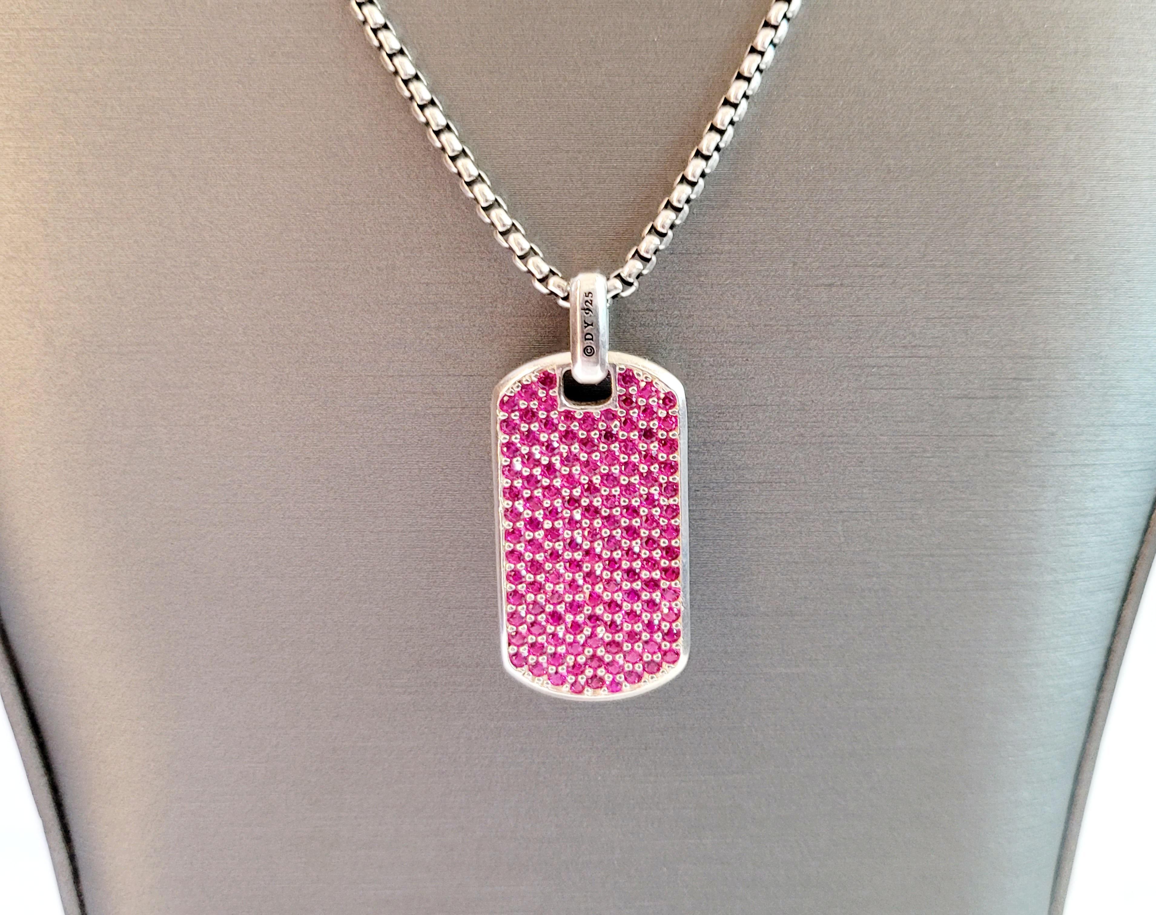 David Yurman Dog Tag pendant with Pink Sapphire
Material Sterling Silver925

Pendant Dimension:
Length: 34.3mm
Width: 18.2mm
Thickness: 3.2mm

Chain dimension:
Length:22''
Width:2.5mm

Total weight gram: 30.6g
Condition: Pre-owned
Retail price for