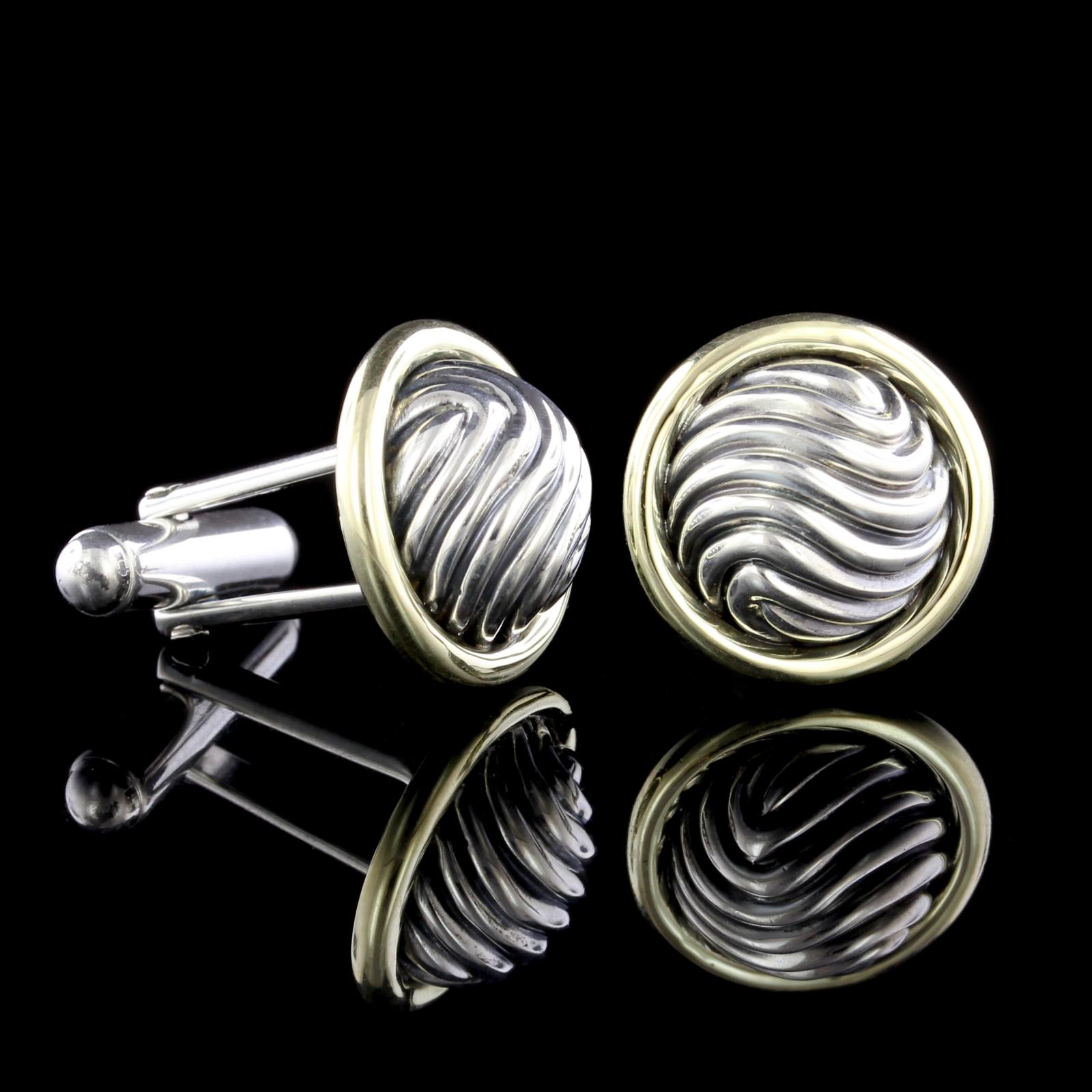 David Yurman Sterling Silver and 14K Yellow Gold Domed Cable Cufflinks.
Diameter 16.70mm.