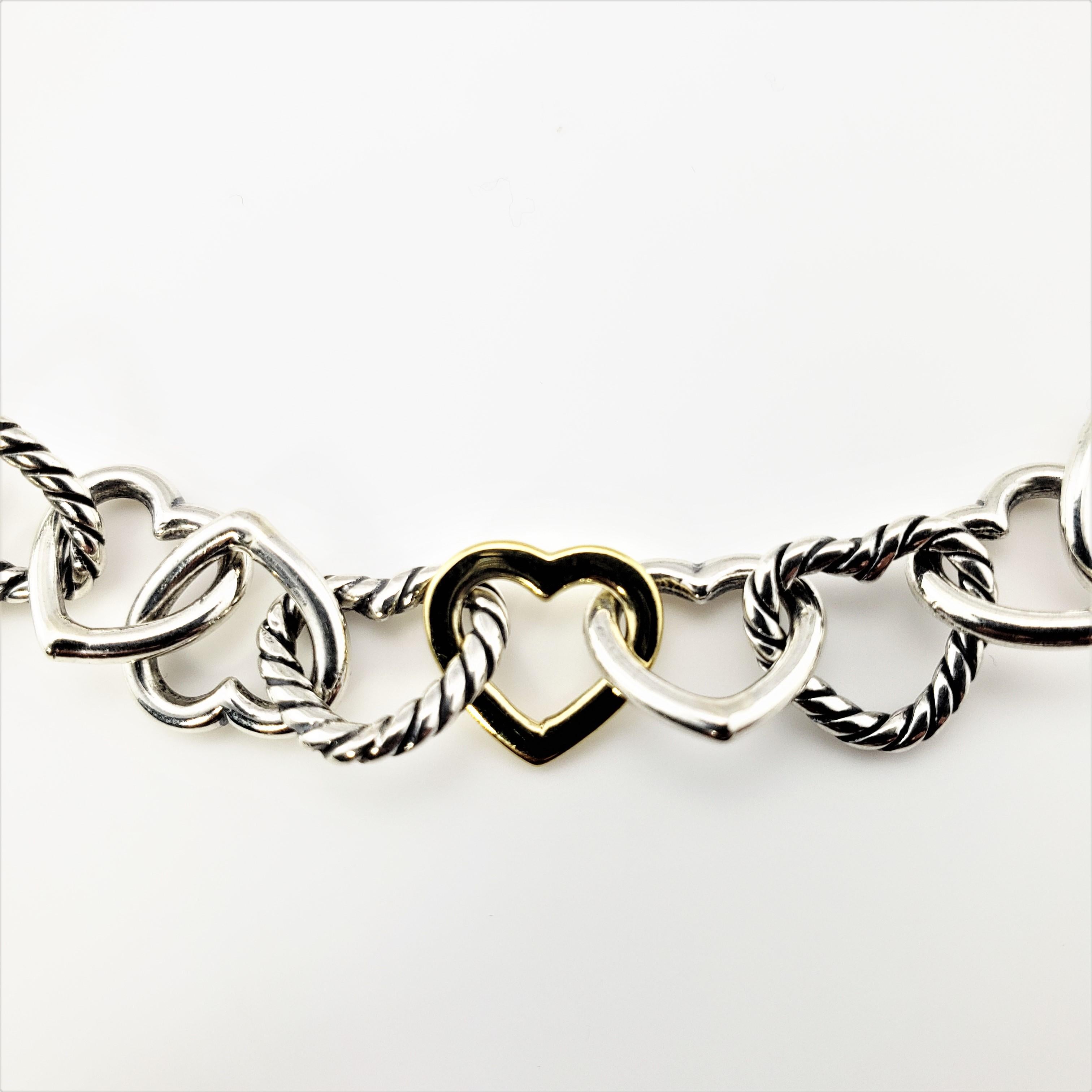 David Yurman Sterling Silver and 18 Karat Yellow Gold Heart Link Necklace-

This stunning heart link necklace is beautifully crafted in sterling silver and 18K yellow gold by David Yurman.  Toggle closure.

Width:  10.2 mm

Size:  15.75