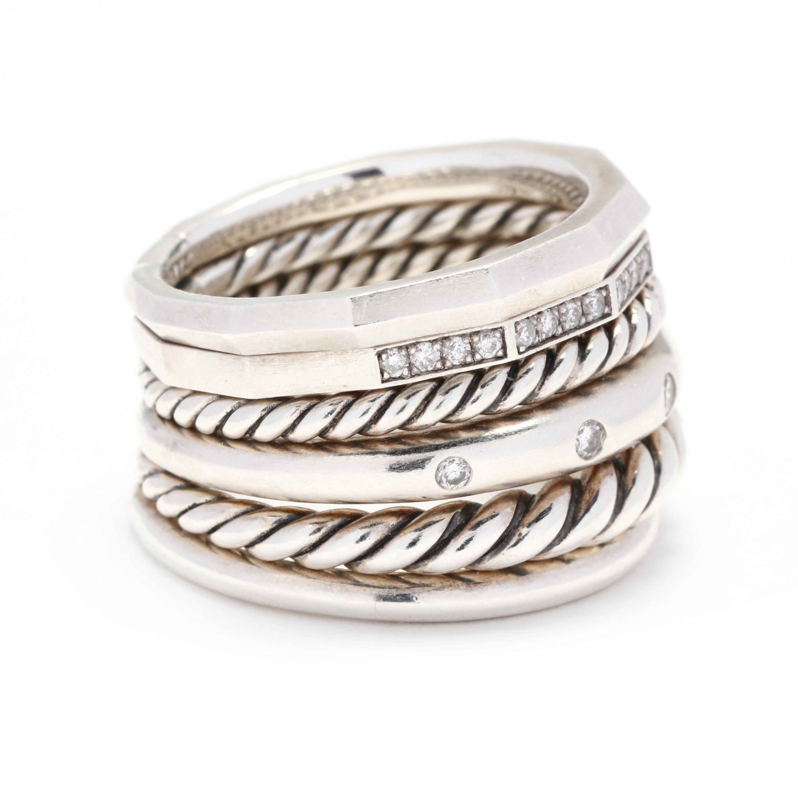 A David Yurman sterling silver and diamond Stax wide multi band ring. This ring features six different types of bands including a plain, tapered rope, spaced diamond, thin rope, geometric diamond and a faceted plain band, all connected at the back