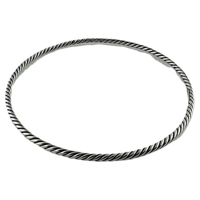 David Yurman Sterling Silver Cable Bangle Bracelet

This classic David Yurman twisted cable bangle bracelet is set in sterling silver.

Stamped DY 925

8