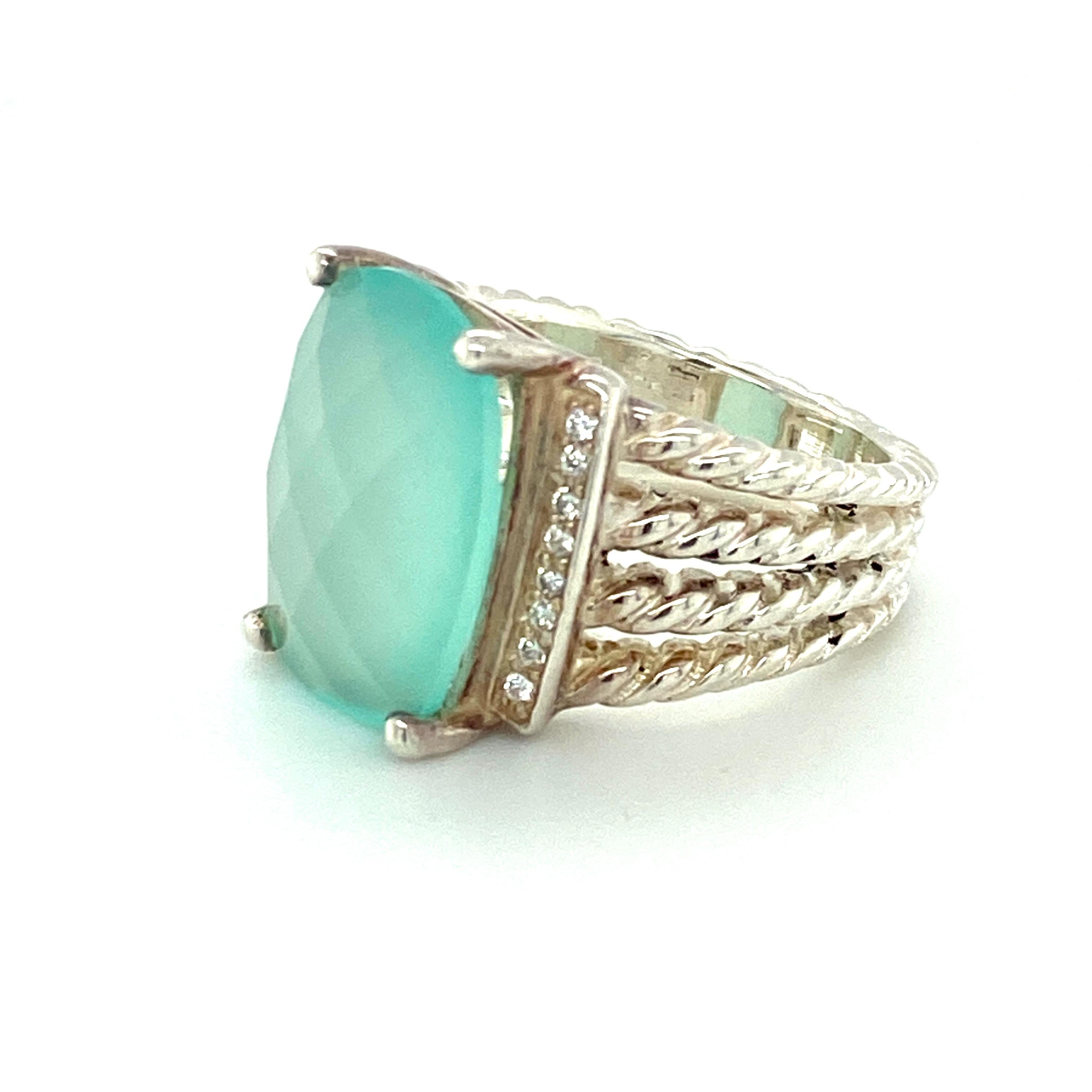 This 4-cable ring model of David Yurman's coveted Wheaton Collection features 16 round brilliant diamonds of approximately 0.12ct total weight surrounding a prong-set faceted blue-green cabochon chalcedony.  The 4-cable sterling silver Wheaton ring