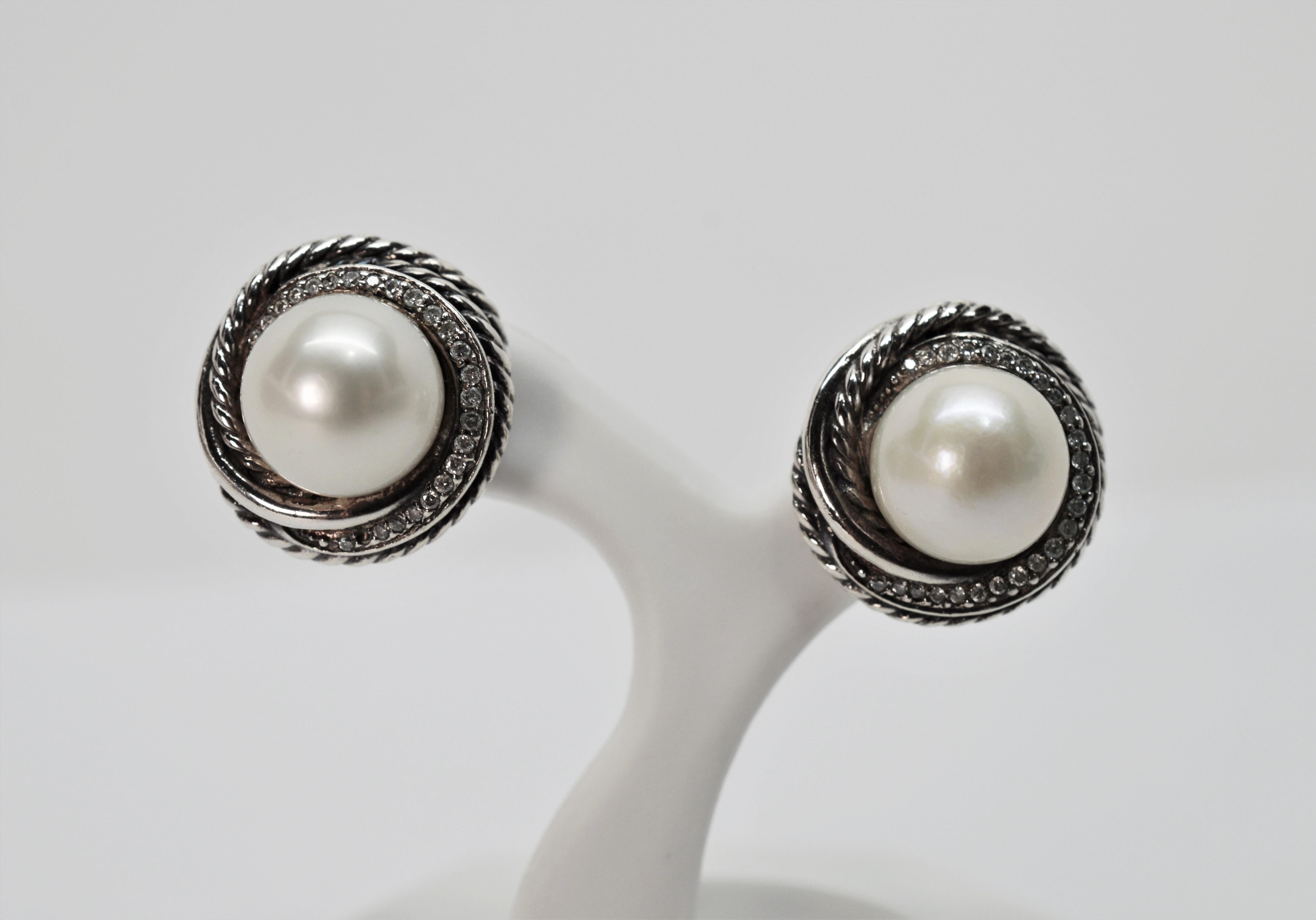 Classic pearl earrings with that DY twist. The David Yurman signature cable design is accented with pave diamonds which creates the perfect nest for the 9.5mm white cultured fresh water pearls that are the focal point for this versatile pair.  The