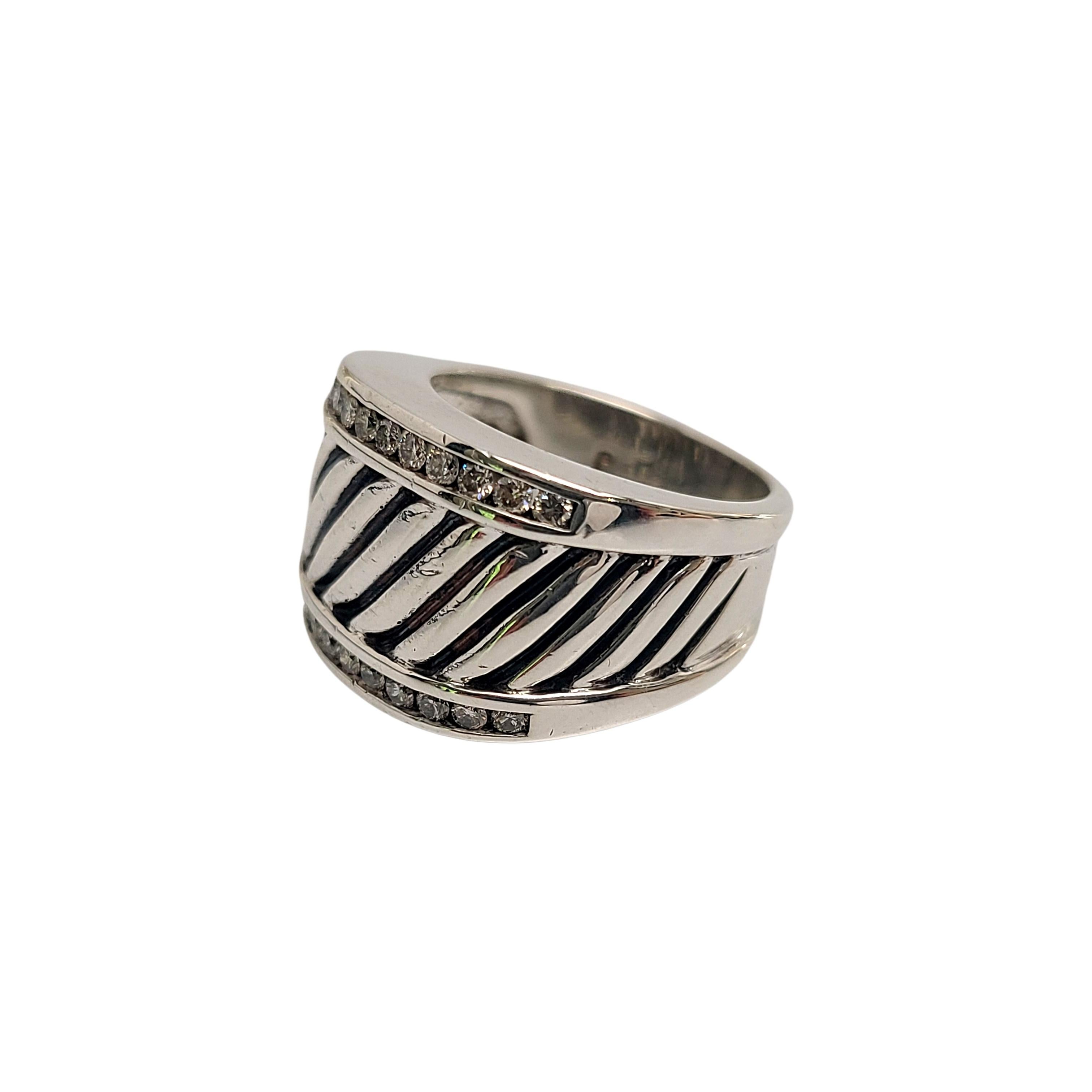 Sterling silver and diamond cigar cable ring by David Yurman.

Size 6 3/4

Features a cable design with 12 small round diamonds bezel set at the top and the bottom of the front of the ring. 24 diamonds total.

Ring measures approx 14.5mm high at
