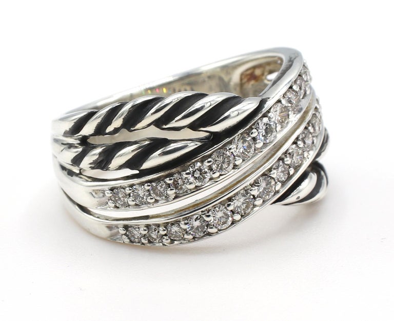 David Yurman Sterling Silver & Diamond Crossover Band Ring 
Metal: Sterling silver 925
Weight: 7.59 grams
Diamonds: Approx. .60 CTW G VS round diamonds
Size: 7 (US)
Width: 5.5 - 10.5mm
Signed: DY 925