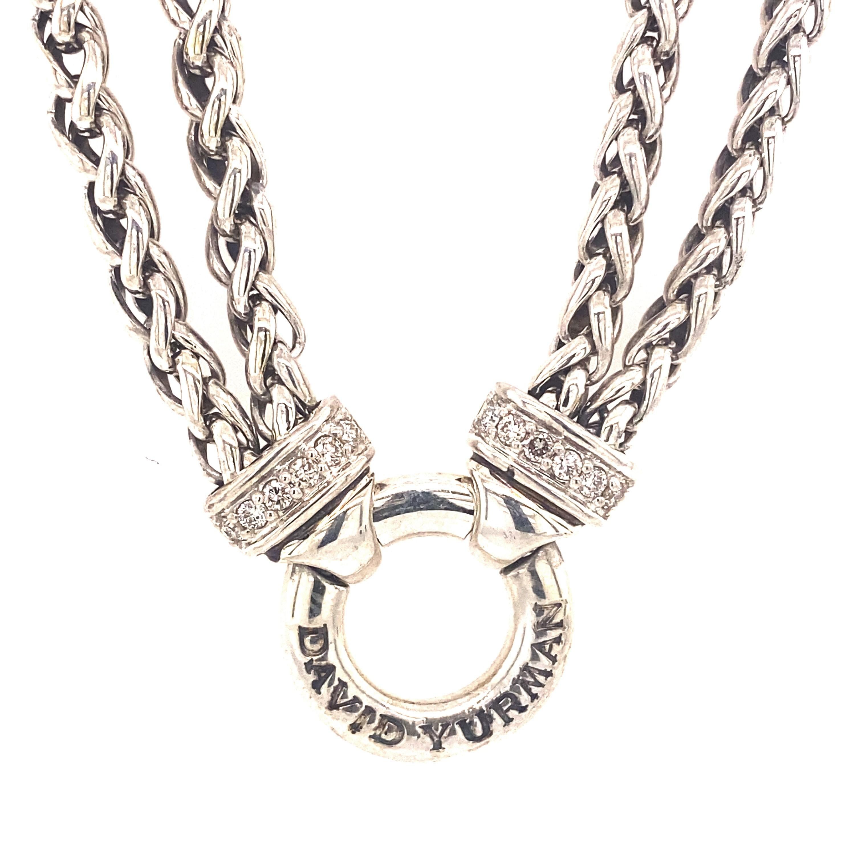 A classic necklace from David Yurman crafted from sterling silver and features two 4mm wheat chains that have .22ctw of pave diamonds and meet at the circle engraved with David Yurman. Pull clasp with classic cable motif. The length is approximately