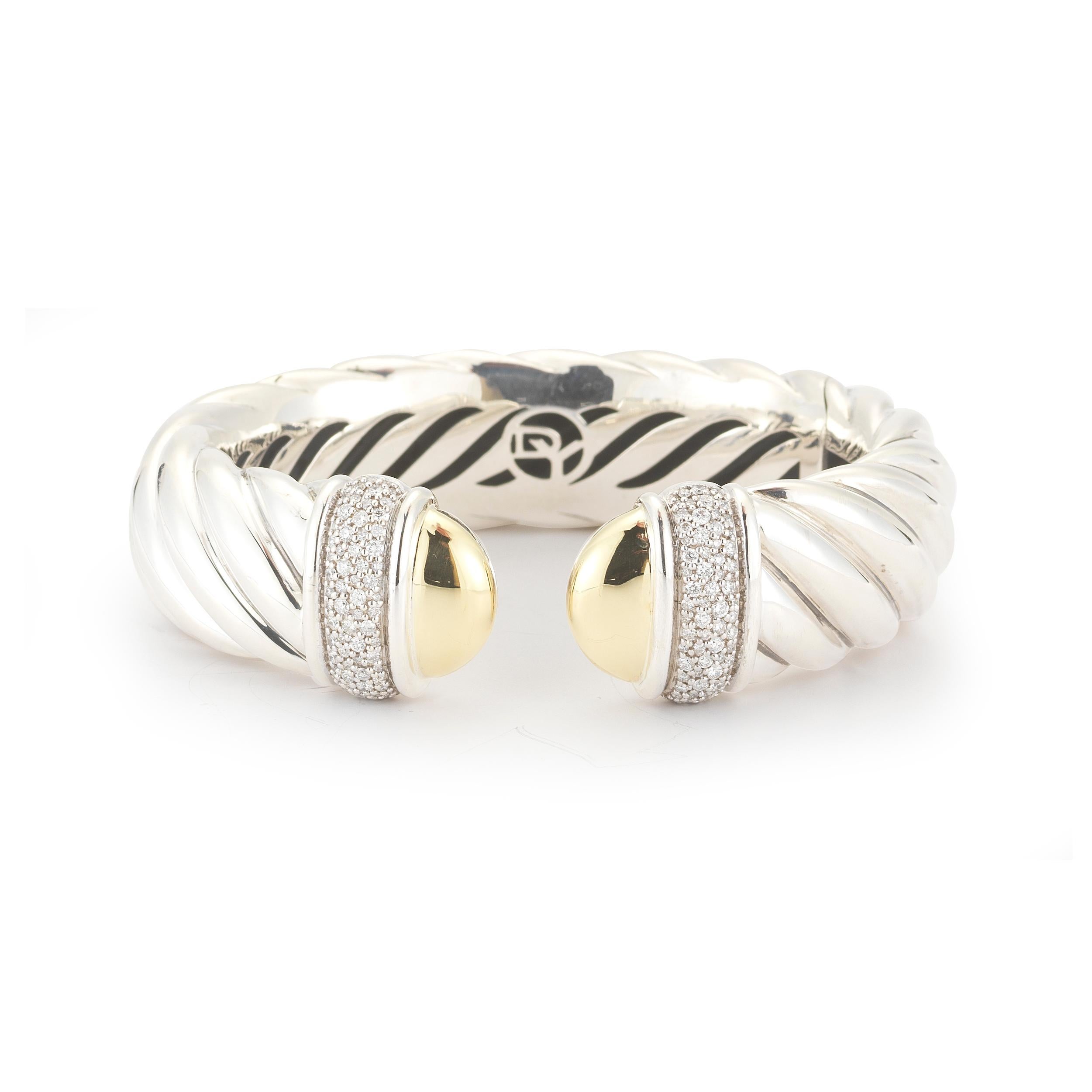 A hinged cuff formed in sterling silver with 18K yellow gold accents features a total of approximately 1.19 carats of round diamonds signed DY, 925, 750. From the David Yurman Waverly Collection. The bracelet measures approximately 18mm in width