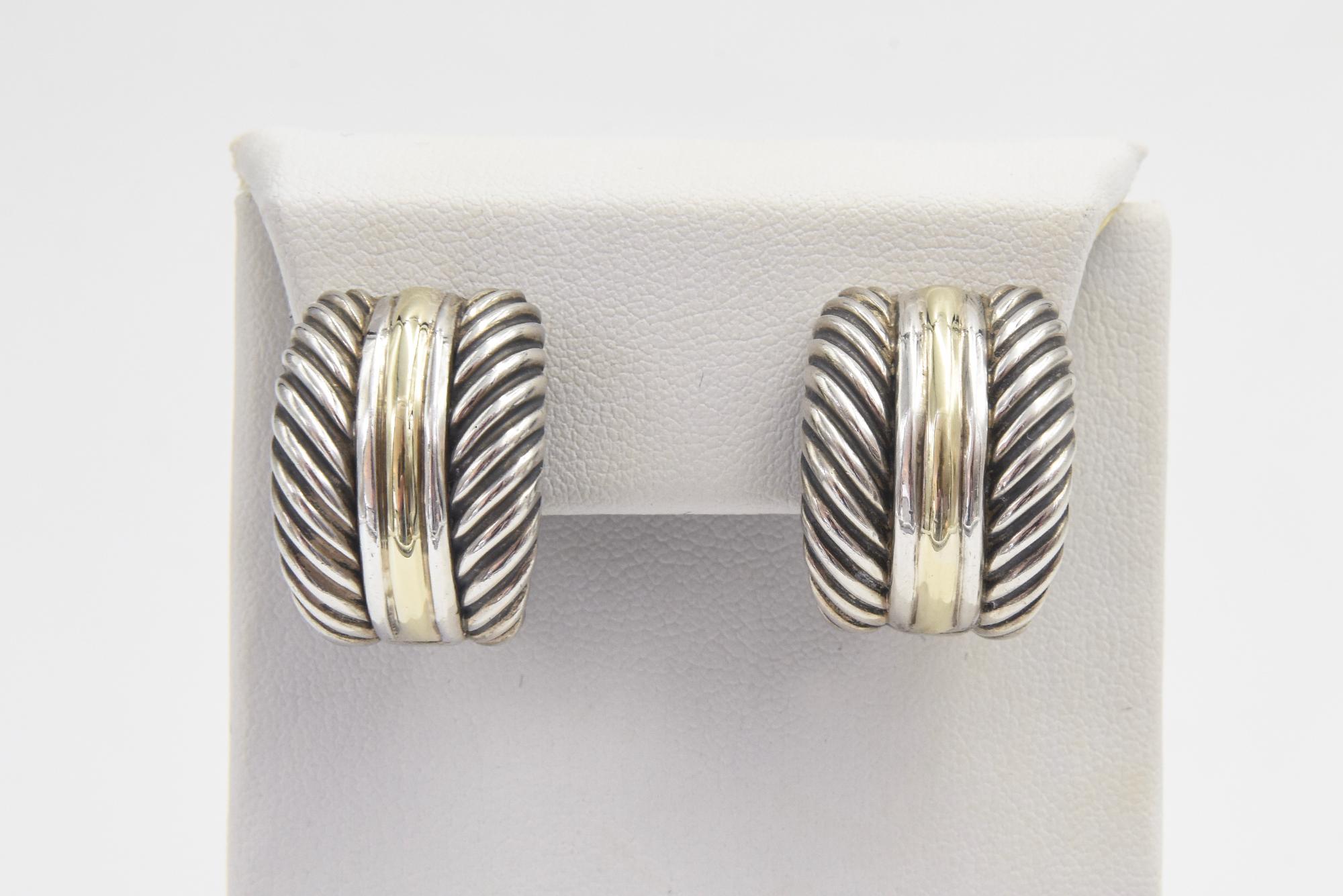 David Yurman cable hoop earring featuring a 14k yellow gold line running between 2 sterling silver lines set between 2 cable sections. Marked D. Yurman 14k Sterling on the back.  