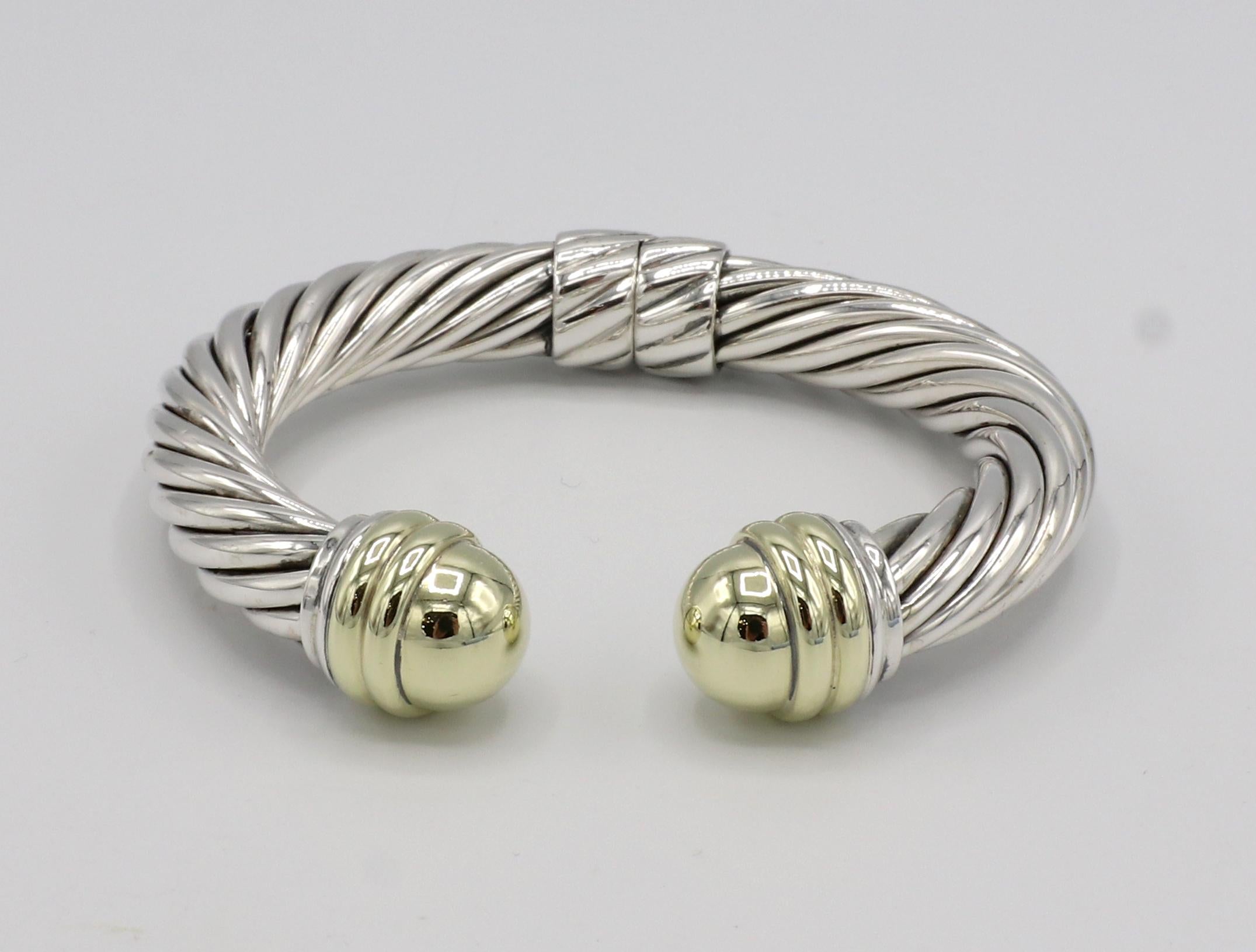 David Yurman Sterling Silver & Gold Hinged Cable Cuff Bangle Bracelet 
Metal: Sterling silver & 14k yellow gold
Weight: 48.5 grams
Width: 9.5mm
Inside diameter: 55mm
Outside diameter: 72mm
Circumference: Approx. 6.25 inches