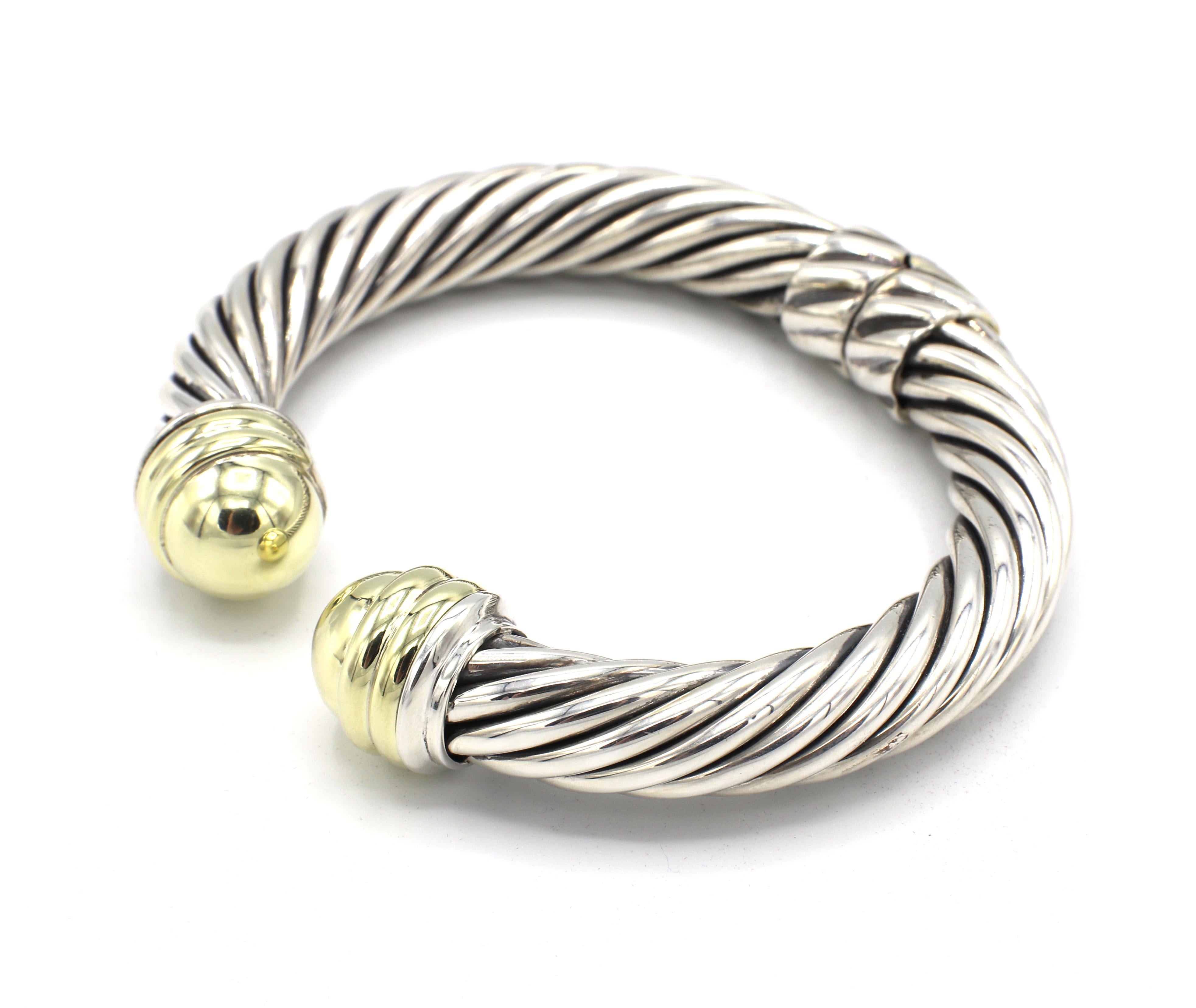 David Yurman Sterling Silver Hinged Cable Classics Bracelet with Gold Domes
Metal: Sterling silver & 14k yellow gold
Weight: 43.8 grams
Diameter: 72.5mm
Width: 9.5 - 14mm
Length: Approx. 6.25 inches 
Signed: D. Yurman Sterling 14k 
Retail: $1,450