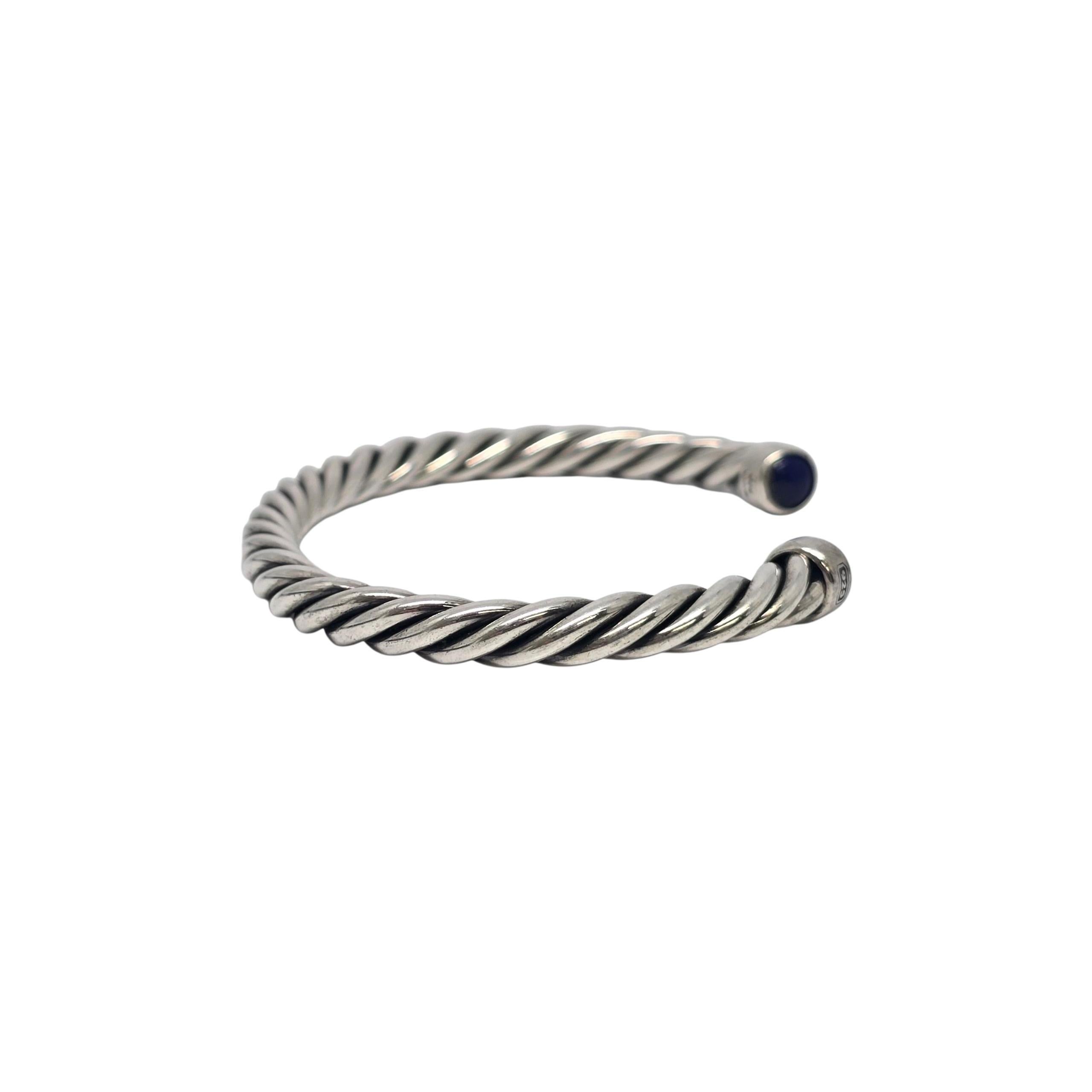 David Yurman sterling silver lapis lazuli men's Cable Cuff Bracelet

David Yurman's classic and iconic twist design cuff bracelet featuring blue lapis end caps.

Weighs approx 39.4g, 25.3dwt

Measures approx 7 1/2